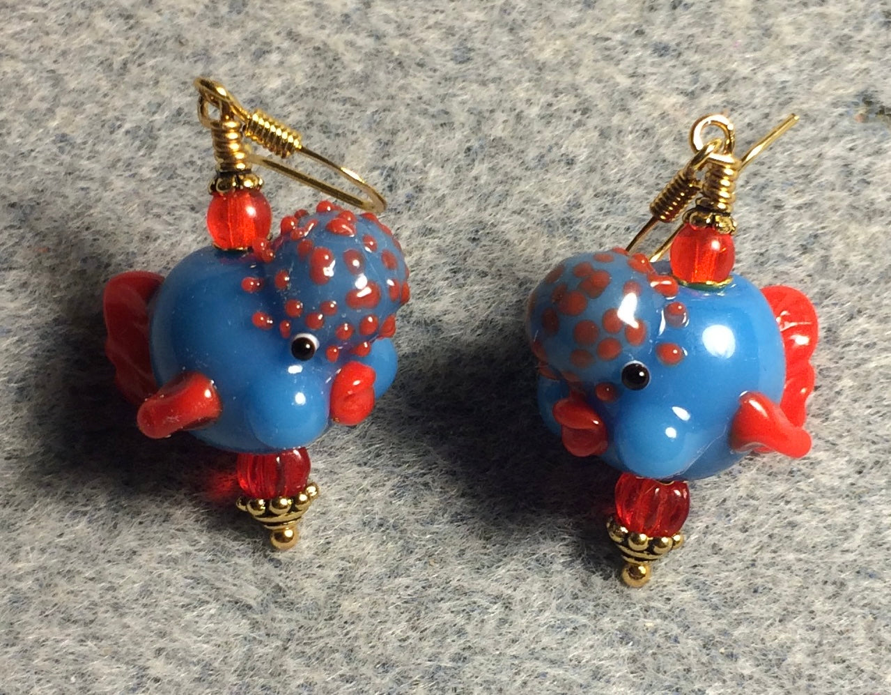 Opaque blue and red lamp work clownfish bead earrings adorned with red Czech glass beads.