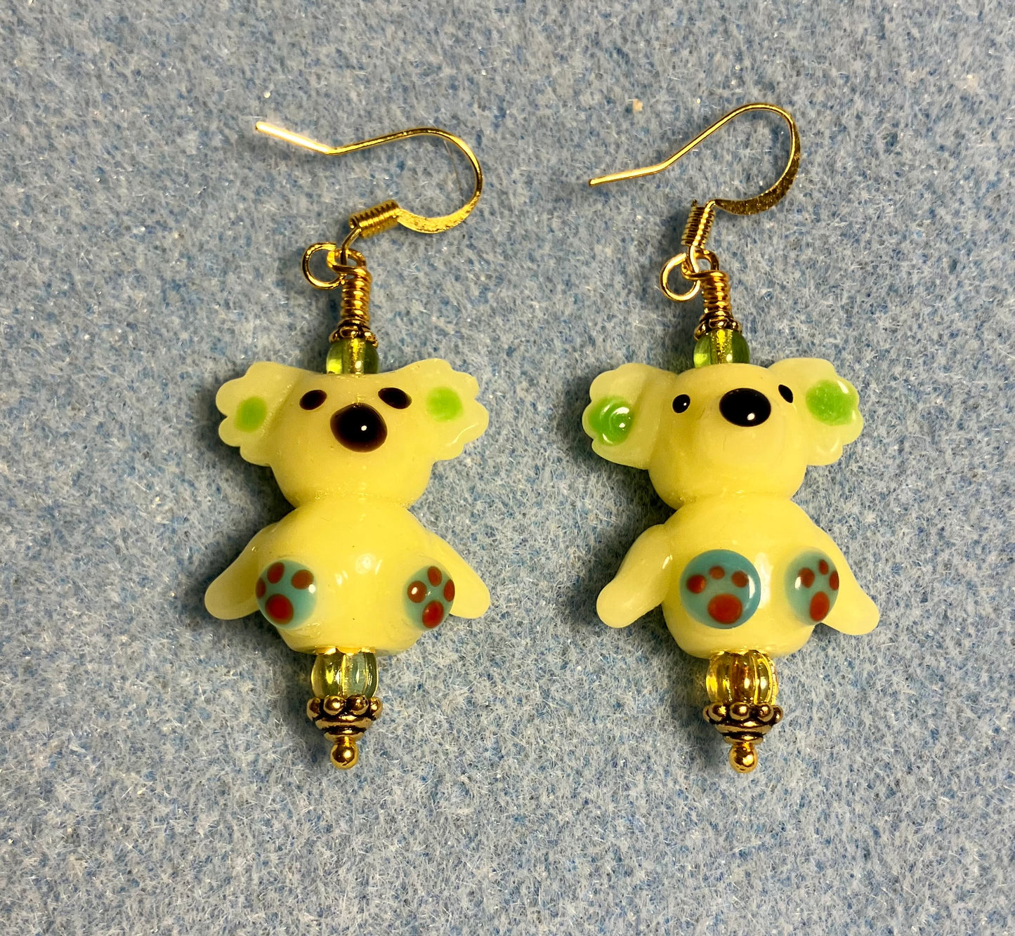 Lime green lamp work koala bear bead earrings adorned with lime green Chinese crystal beads.