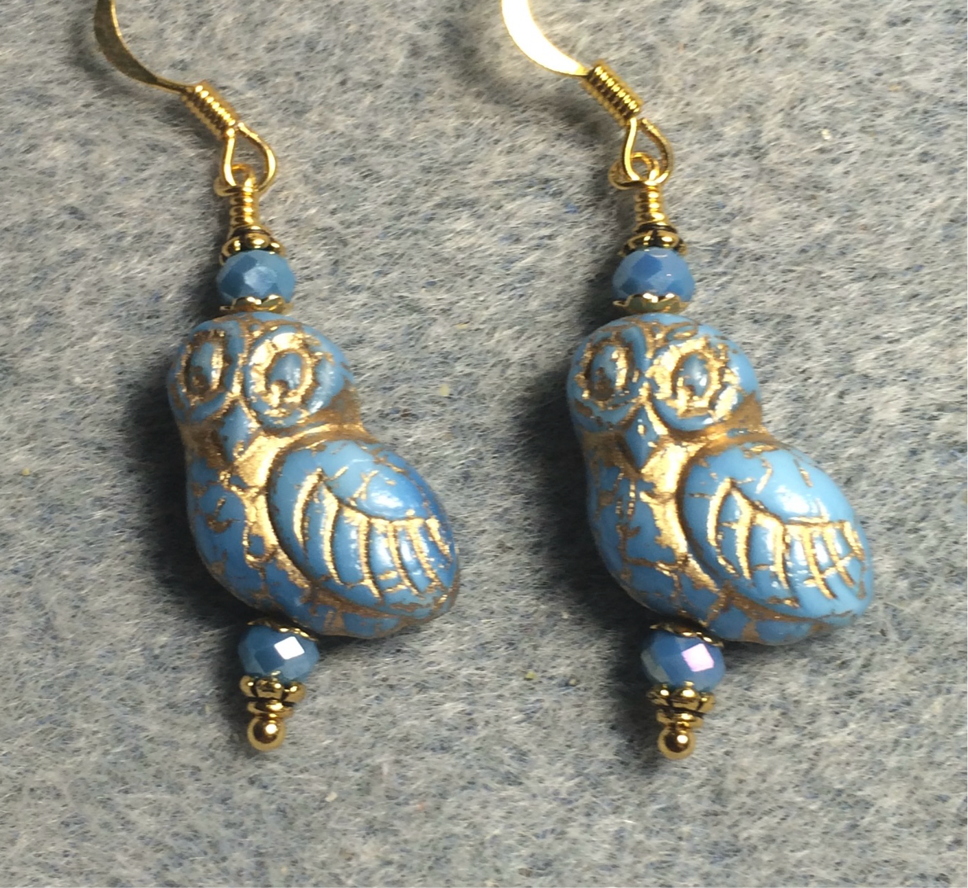 Light blue (with gold wash) fancy Czech glass owl bead earrings adorned with light blue Chinese crystal beads.
