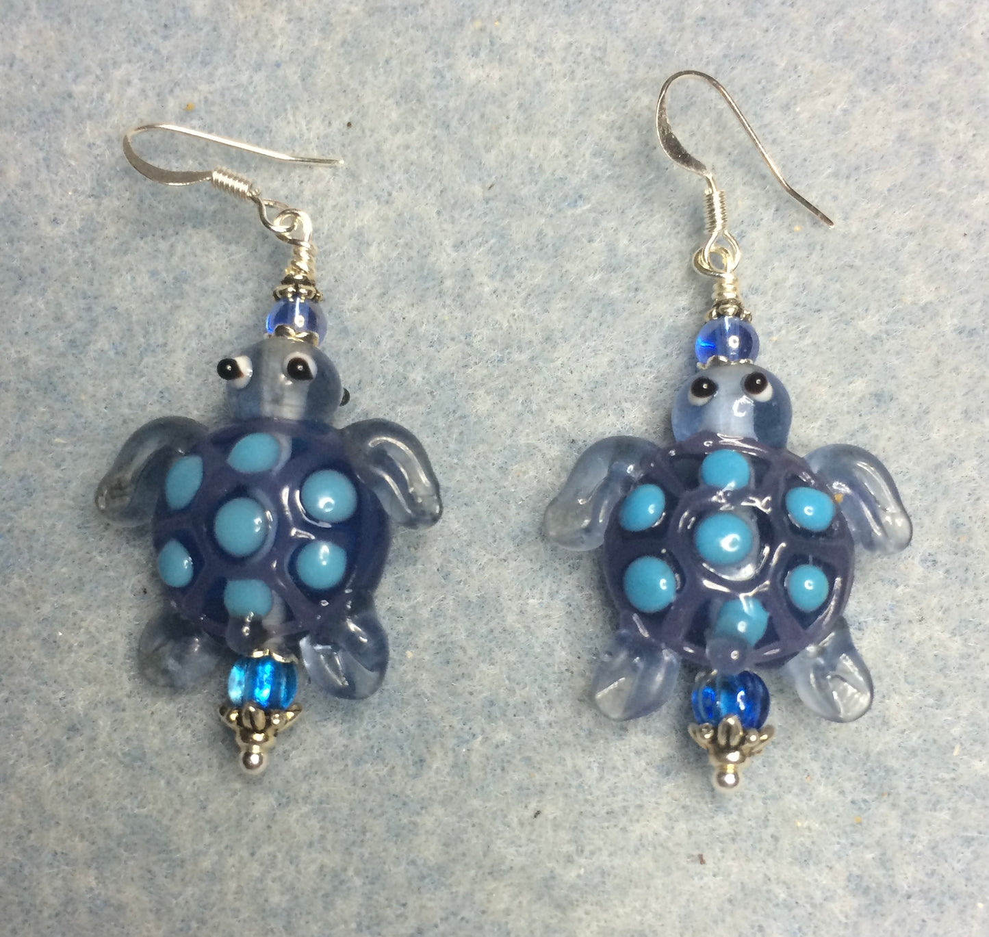 Blue lamp work spotted turtle bead earrings adorned with blue Czech glass beads.