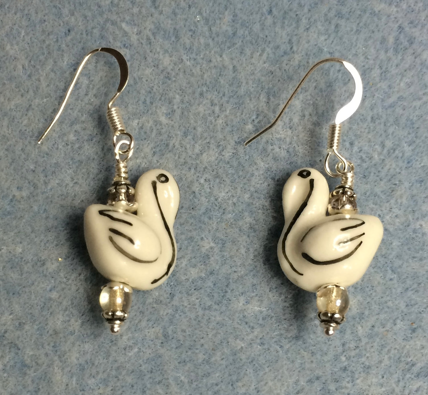 Small white and black ceramic swan bead earrings adorned with clear Chinese crystal beads.