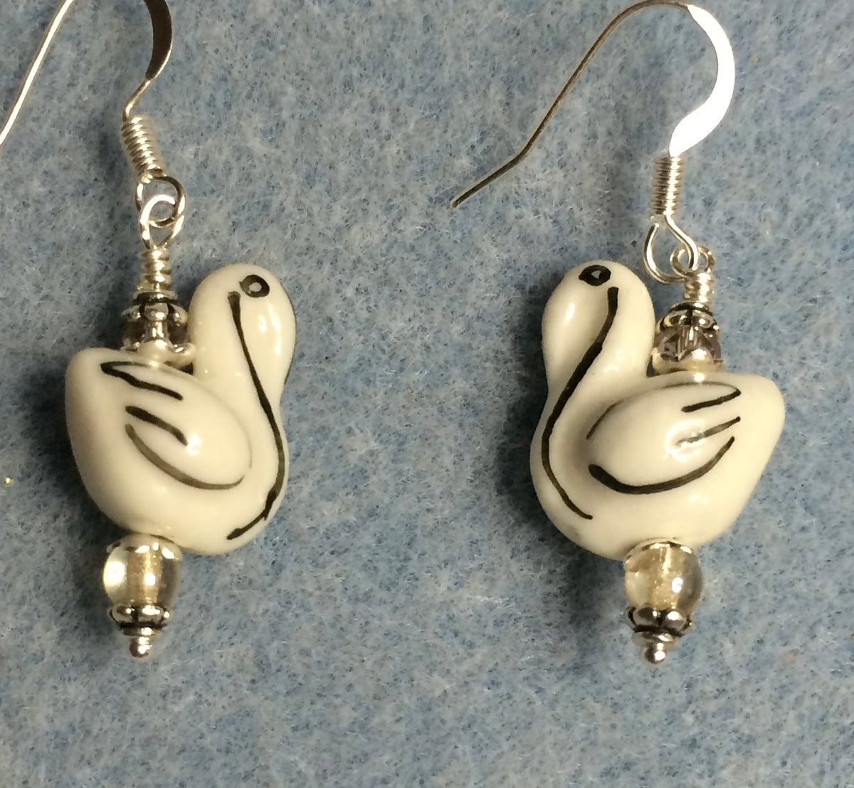 Small white and black ceramic swan bead earrings adorned with clear Chinese crystal beads.