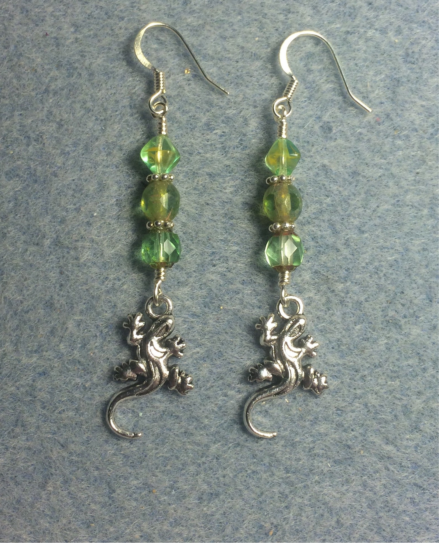 Small silver lizard charm earrings adorned with light green Czech glass beads