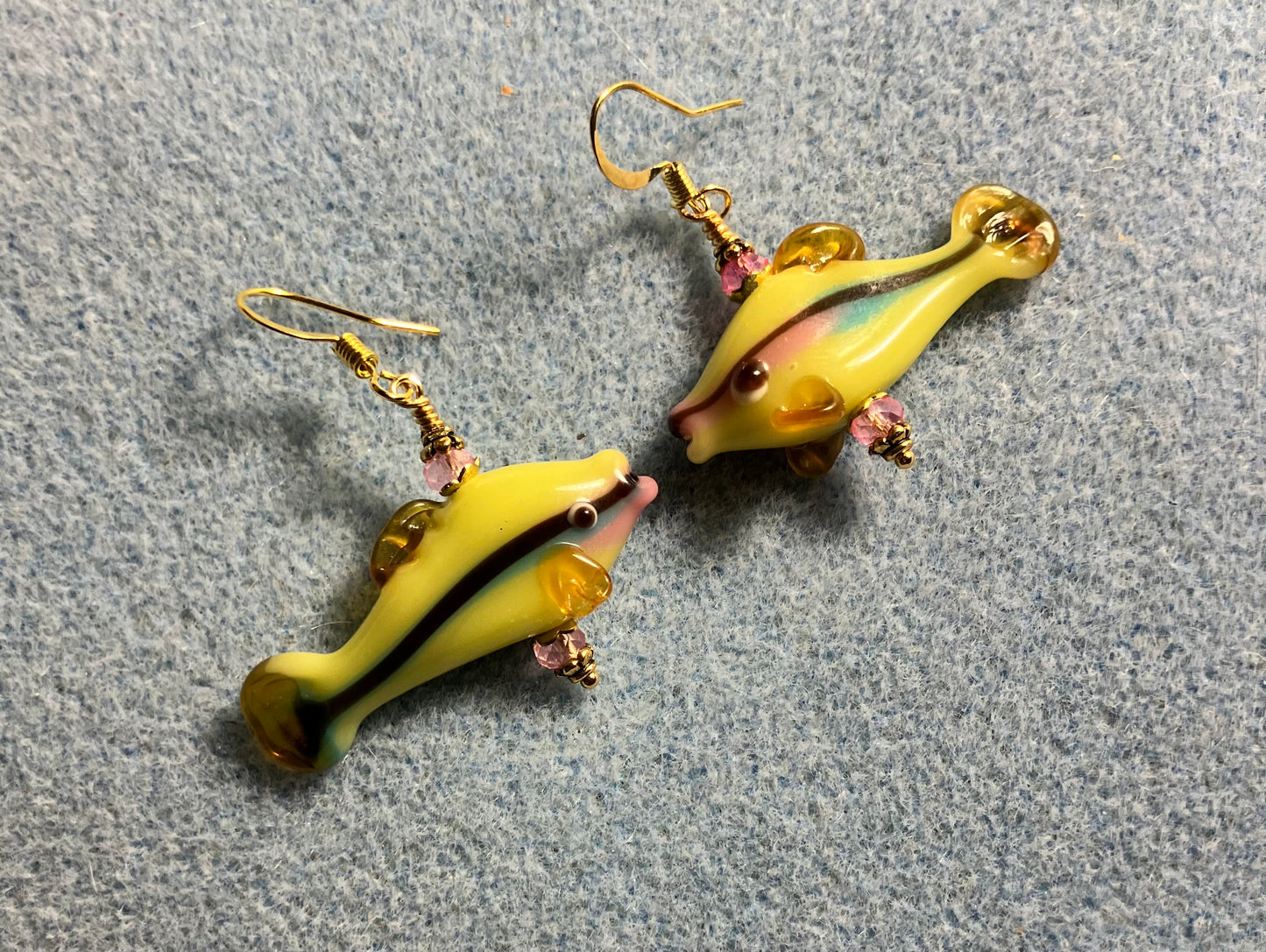 Yellow, pink, and green lamp work bead earrings adorned with pink Chinese crystal beads.