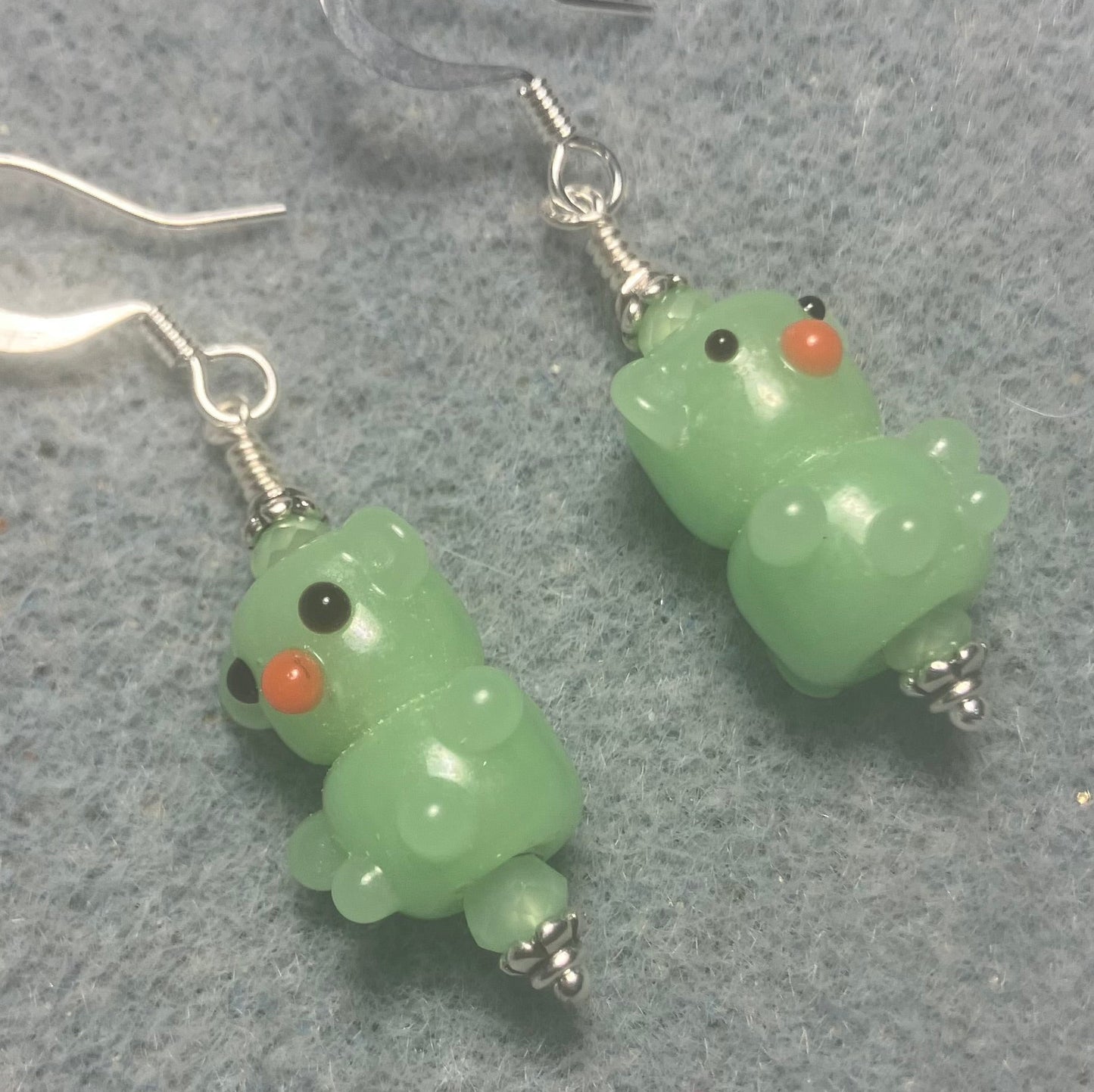 Small light green lamp work teddy bear bead earrings adorned with light green Chinese crystal beads.