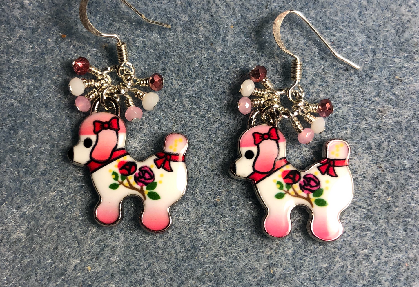 Pink, white, and green enamel dog charm earrings adorned with tiny dangling pink and white Chinese crystal beads.