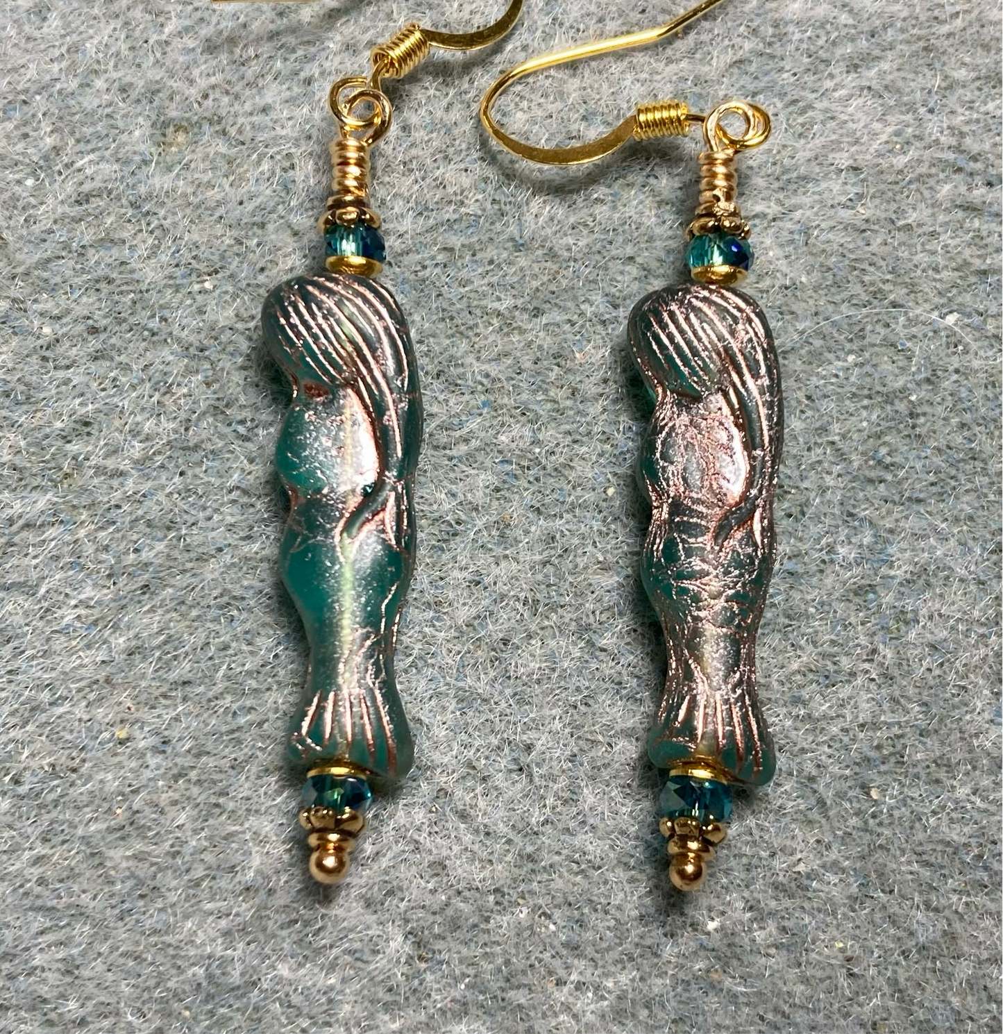 Teal (with copper inlay) Czech glass mermaid bead earrings adorned with teal Chinese crystal beads.