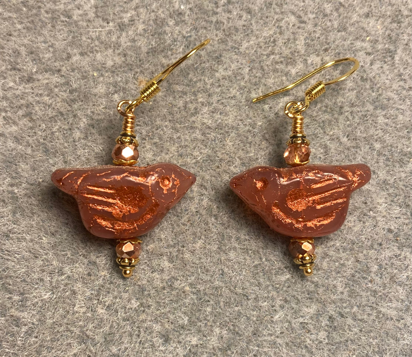Orange (with copper wash) Czech glass bird bead earrings adorned with gold Chinese crystal beads.
