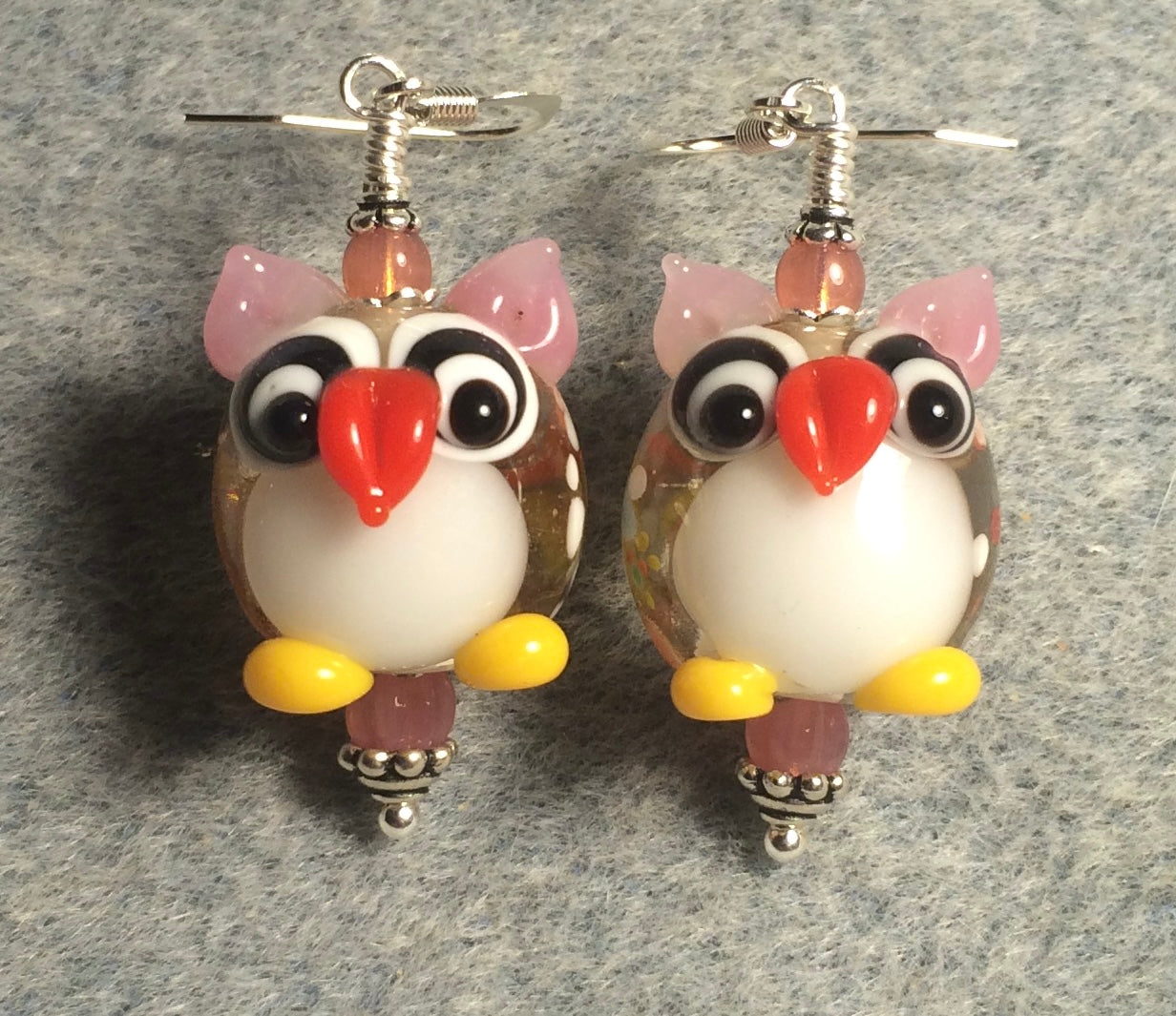 Pink and white lamp work owl bead earrings adorned with pink Czech glass beads.
