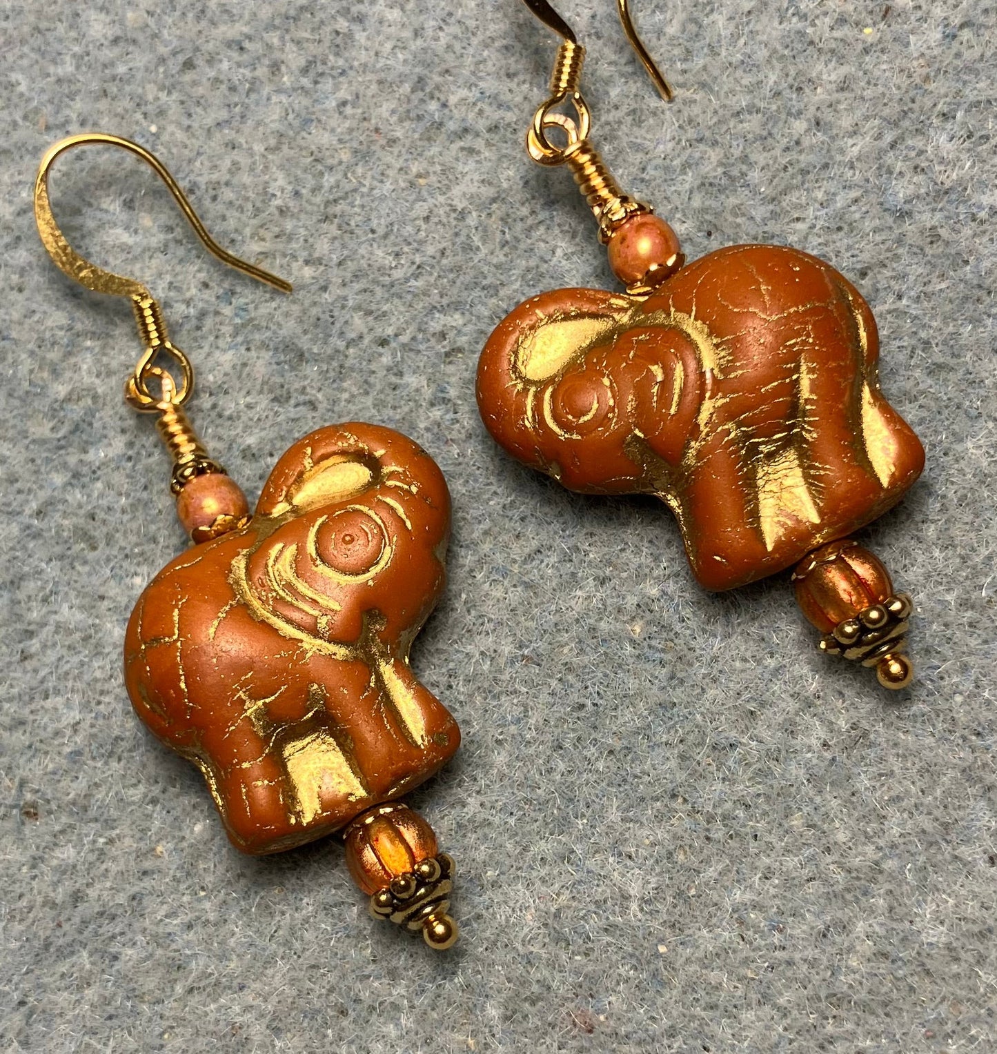 Light orange (with gold inlay) Czech glass elephant bead earrings adorned with light orange Czech glass beads.