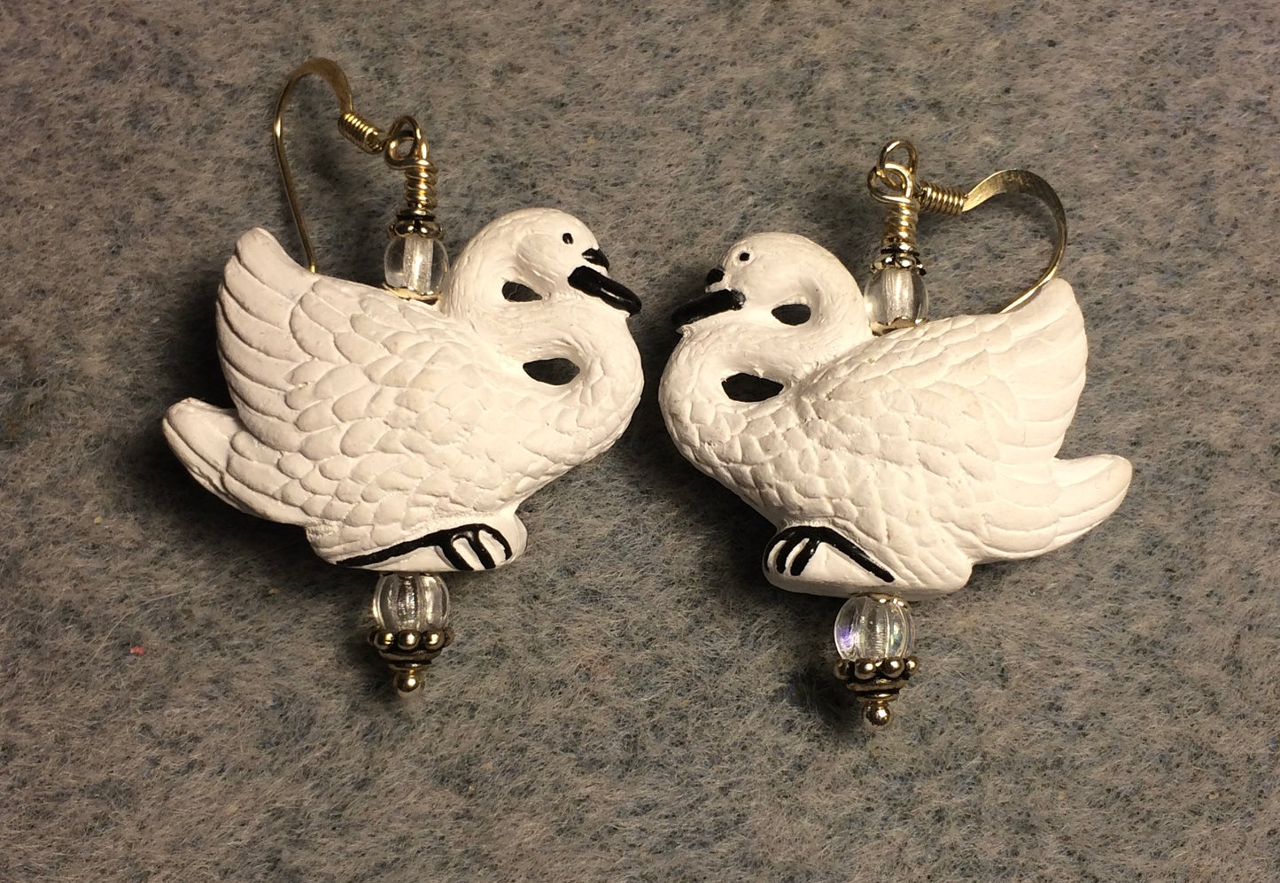 White ceramic long necked swan bead earrings adorned with clear Czech glass beads.