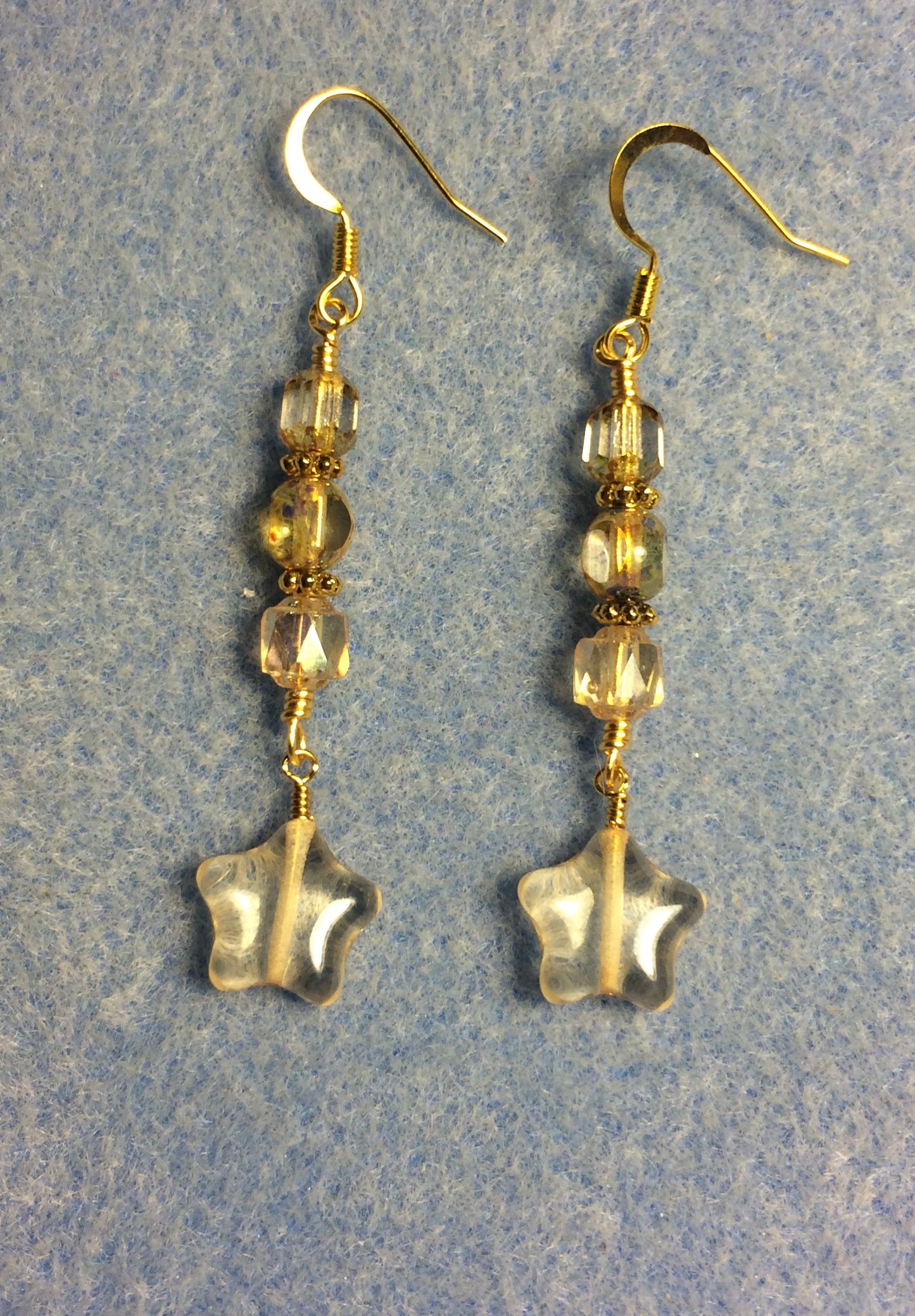 Small translucent yellow Czech glass star bead earrings adorned with yellowish clear Czech glass beads.