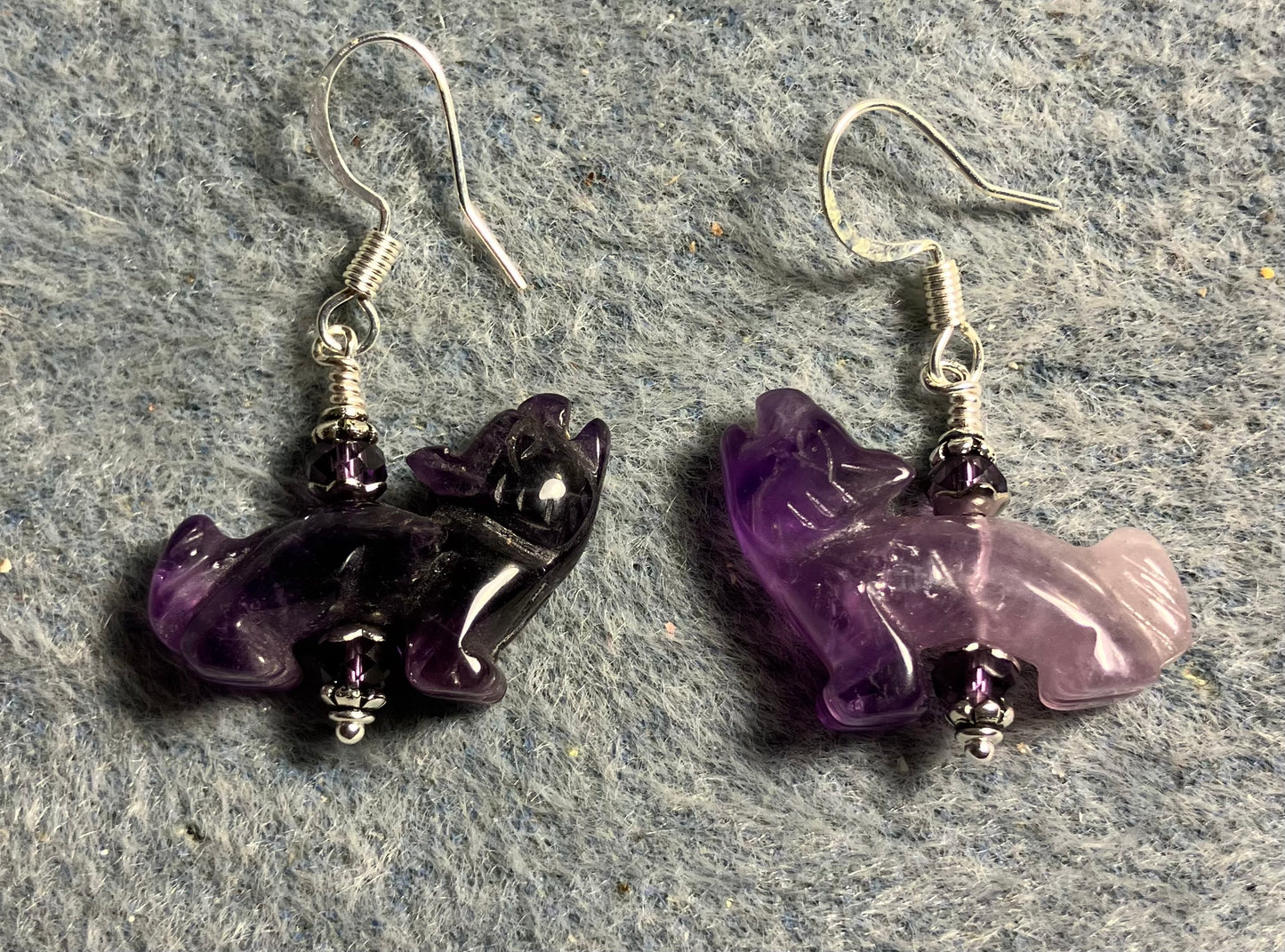 Amethyst gemstone howling coyote bead earrings adorned with purple Chinese crystal beads.