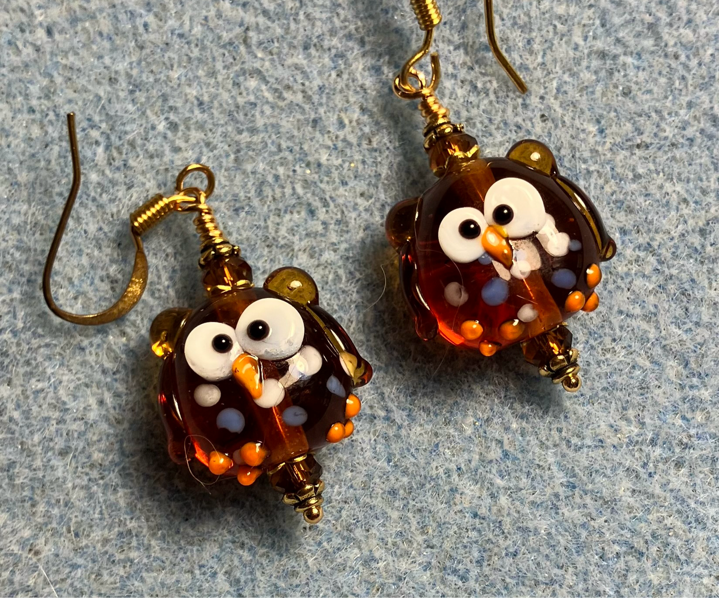Caramel colored lamp work spotted owl bead earrings adorned with caramel Chinese crystal beads.