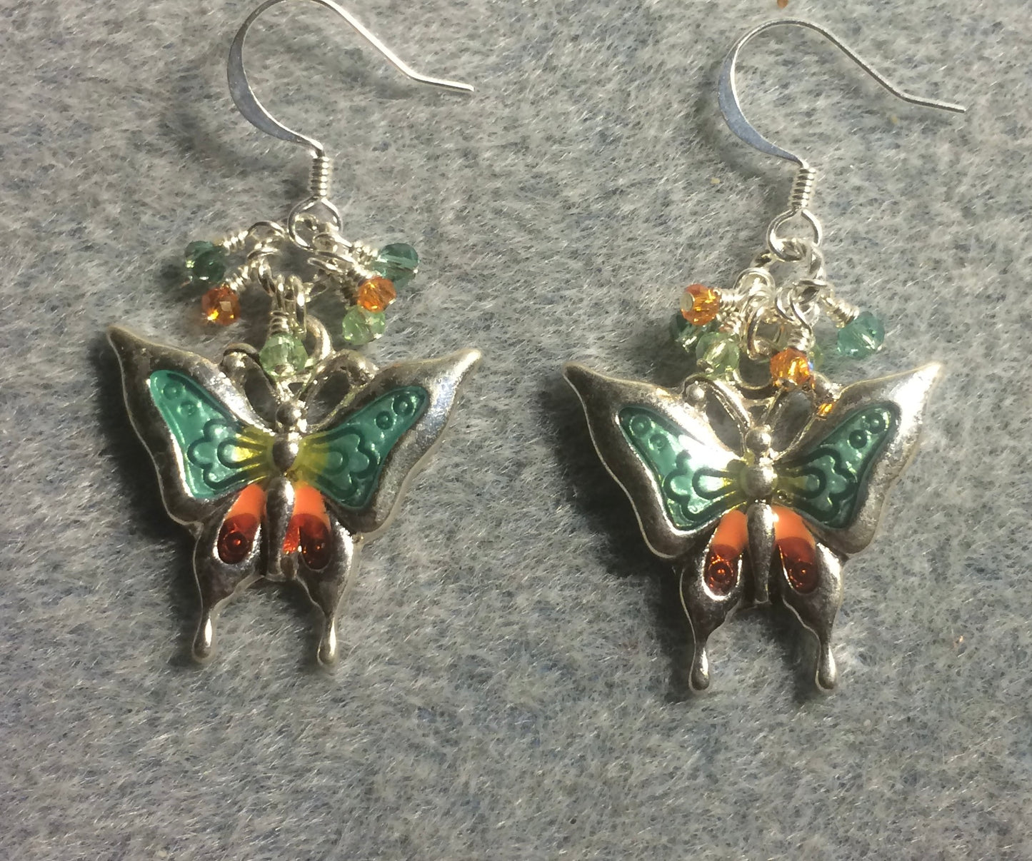 Light green, orange, and silver enamel and rhinestone butterfly charm earrings adorned with tiny dangling light green, orange, and clear Chinese crystal beads.