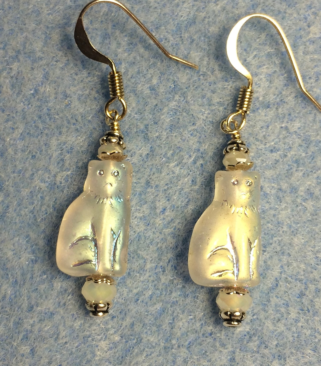 Small metallic white Czech glass cat bead earrings adorned with sparkly white Chinese crystal beads.