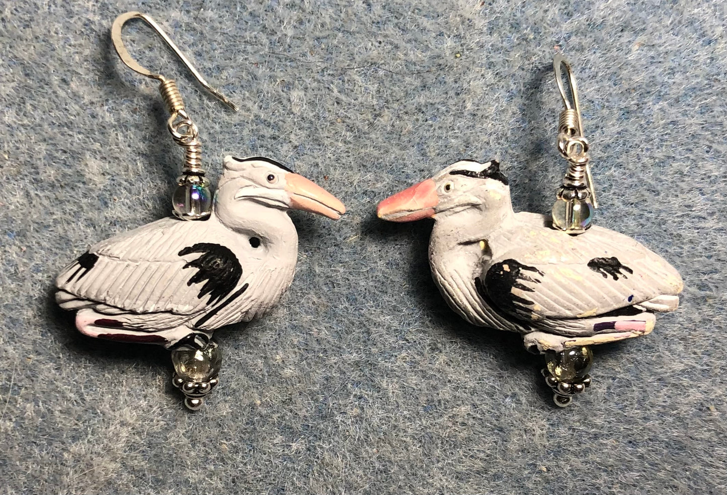 Gray ceramic heron bead earrings adorned with clear Czech glass beads.