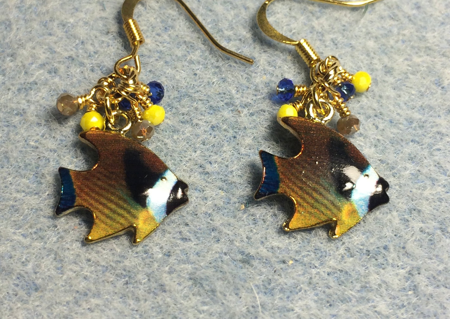 Dark blue, brown, and yellow enamel angelfish charm earrings adorned with tiny dangling dark blue, brown, and yellow Chinese crystal beads.