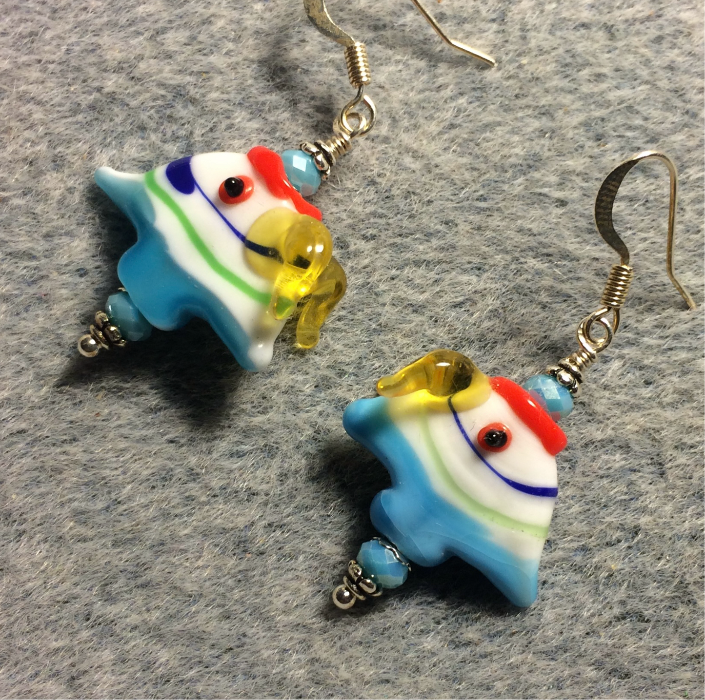 Blue, yellow, and red lamp work angelfish bead earrings adorned with blue Czech glass beads.