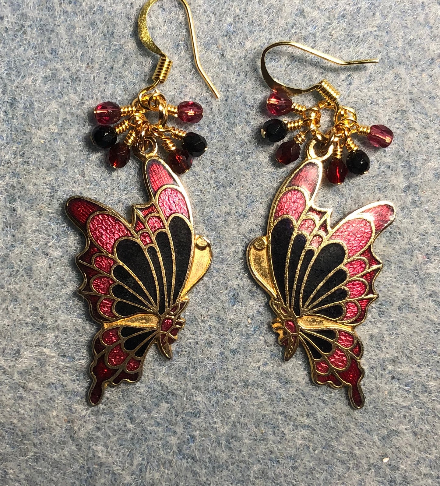 Red, black, and rose cloisonné butterfly charm earrings adorned with small dangling red, black, and rose Czech glass beads.
