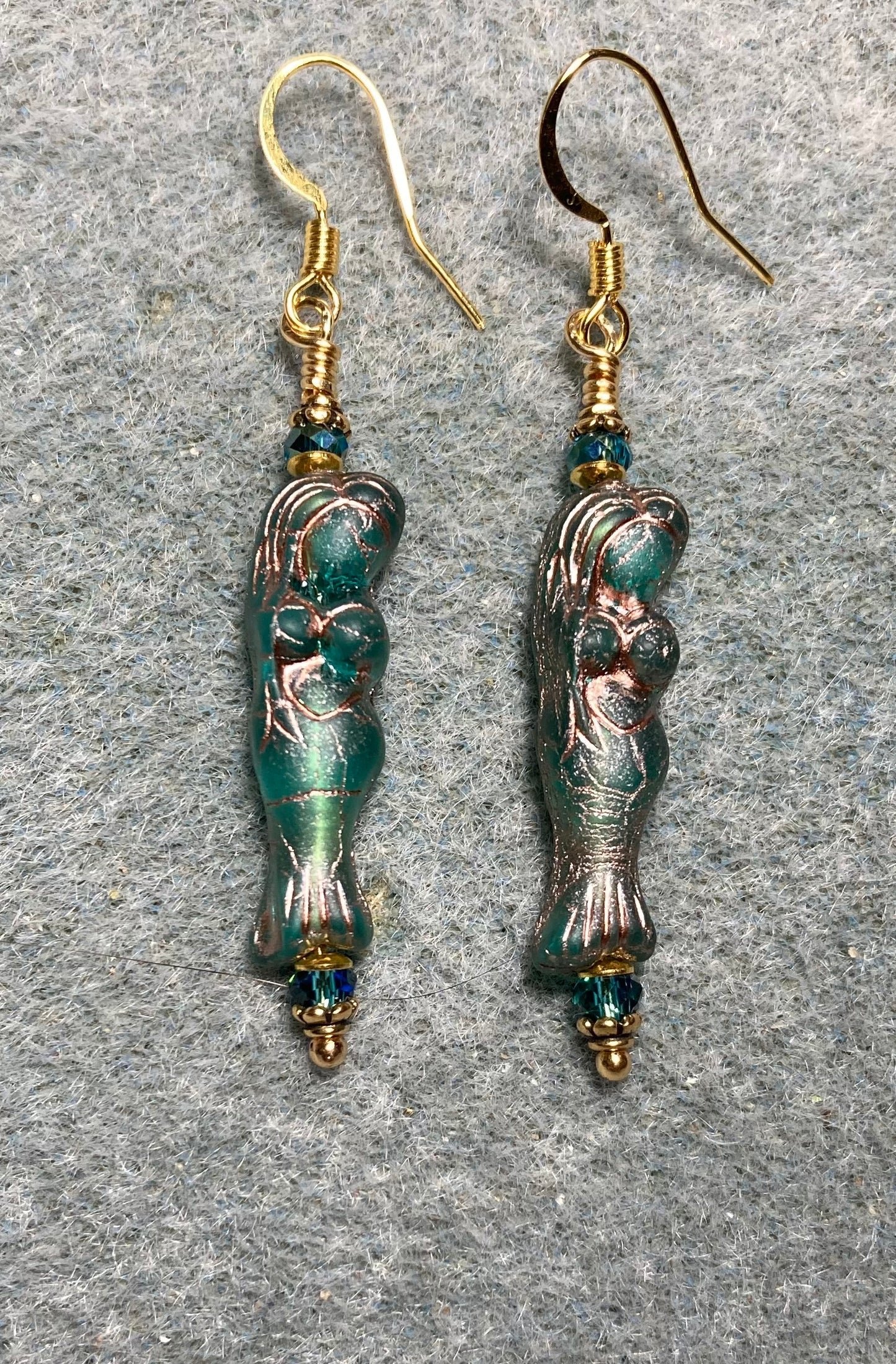Teal (with copper inlay) Czech glass mermaid bead earrings adorned with teal Chinese crystal beads.