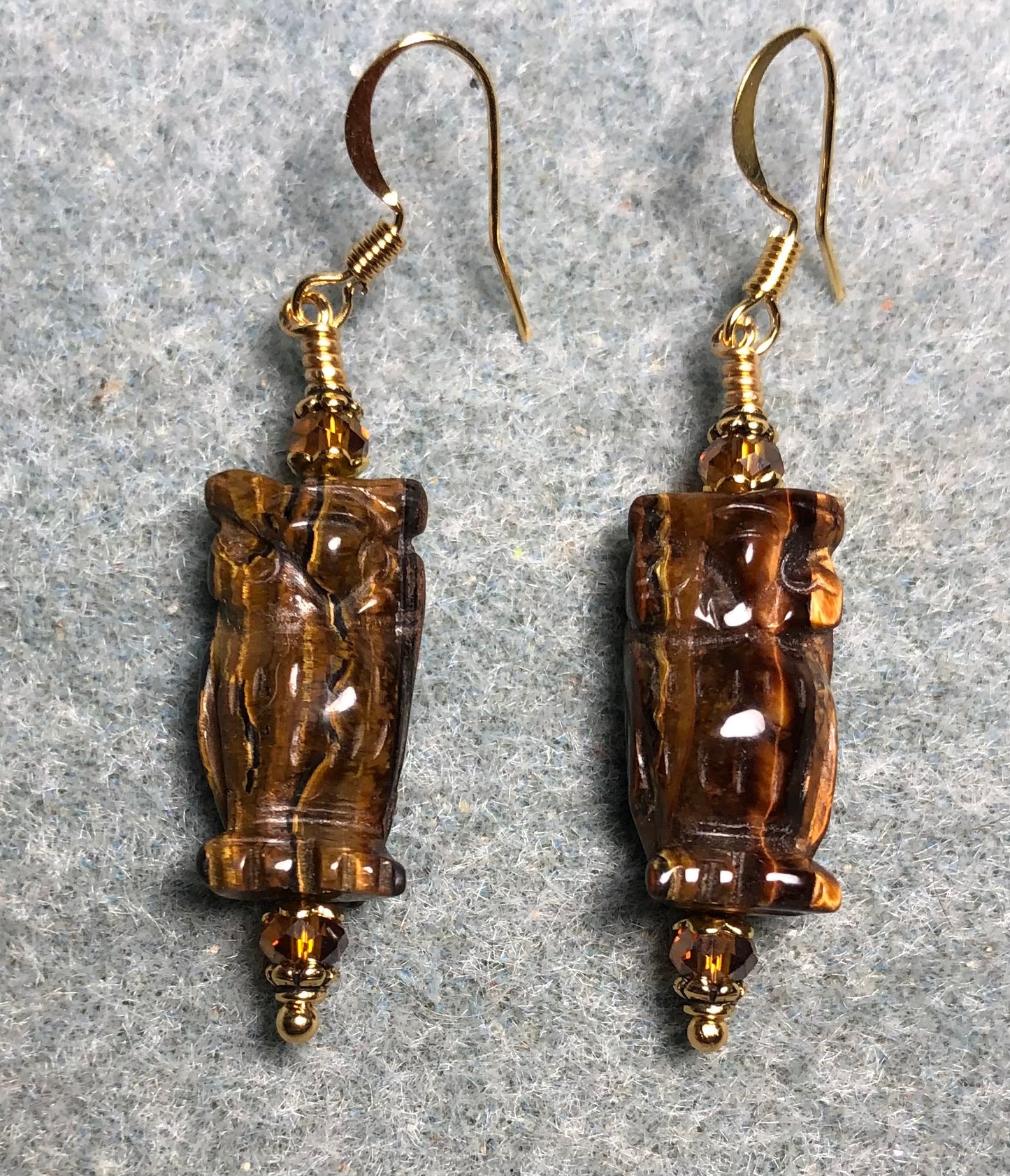 Brown tigereye gemstone owl bead earrings adorned with amber Chinese crystal beads.