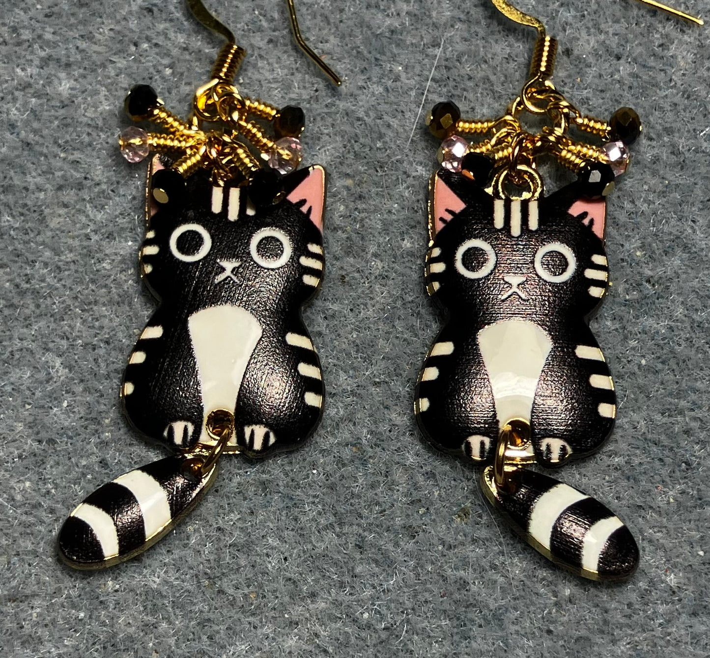 Black, white, and pink enamel cat charm earrings adorned with tiny dangling black, white, and pink Chinese crystal beads.