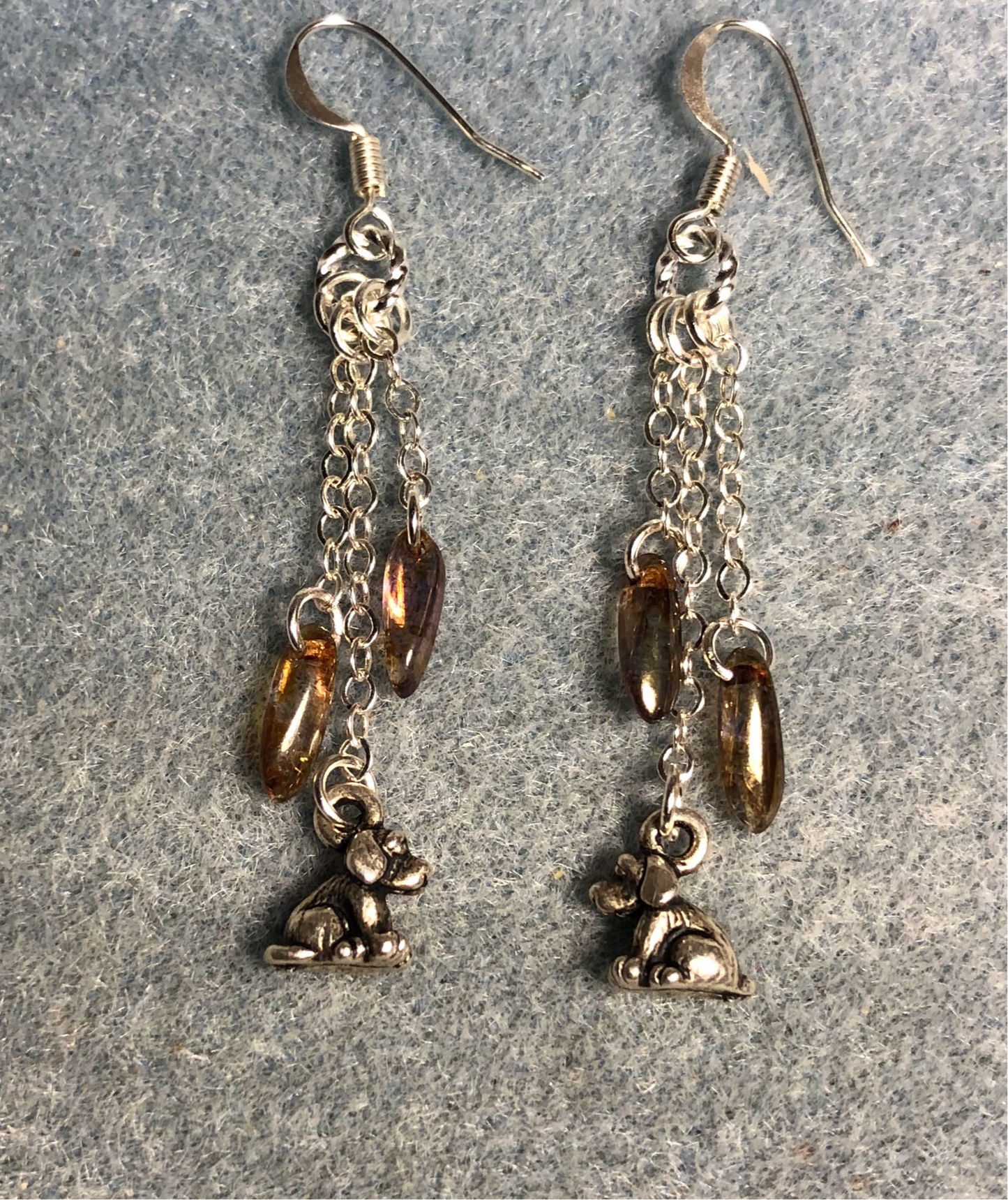 Small silver dog charm earrings attached to silver chain and adorned with small brown Czech glass dagger beads