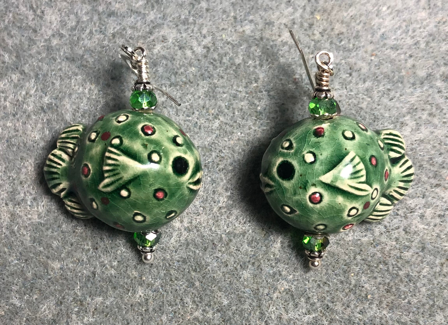Green ceramic blowfish bead earrings adorned with green Chinese crystal beads.