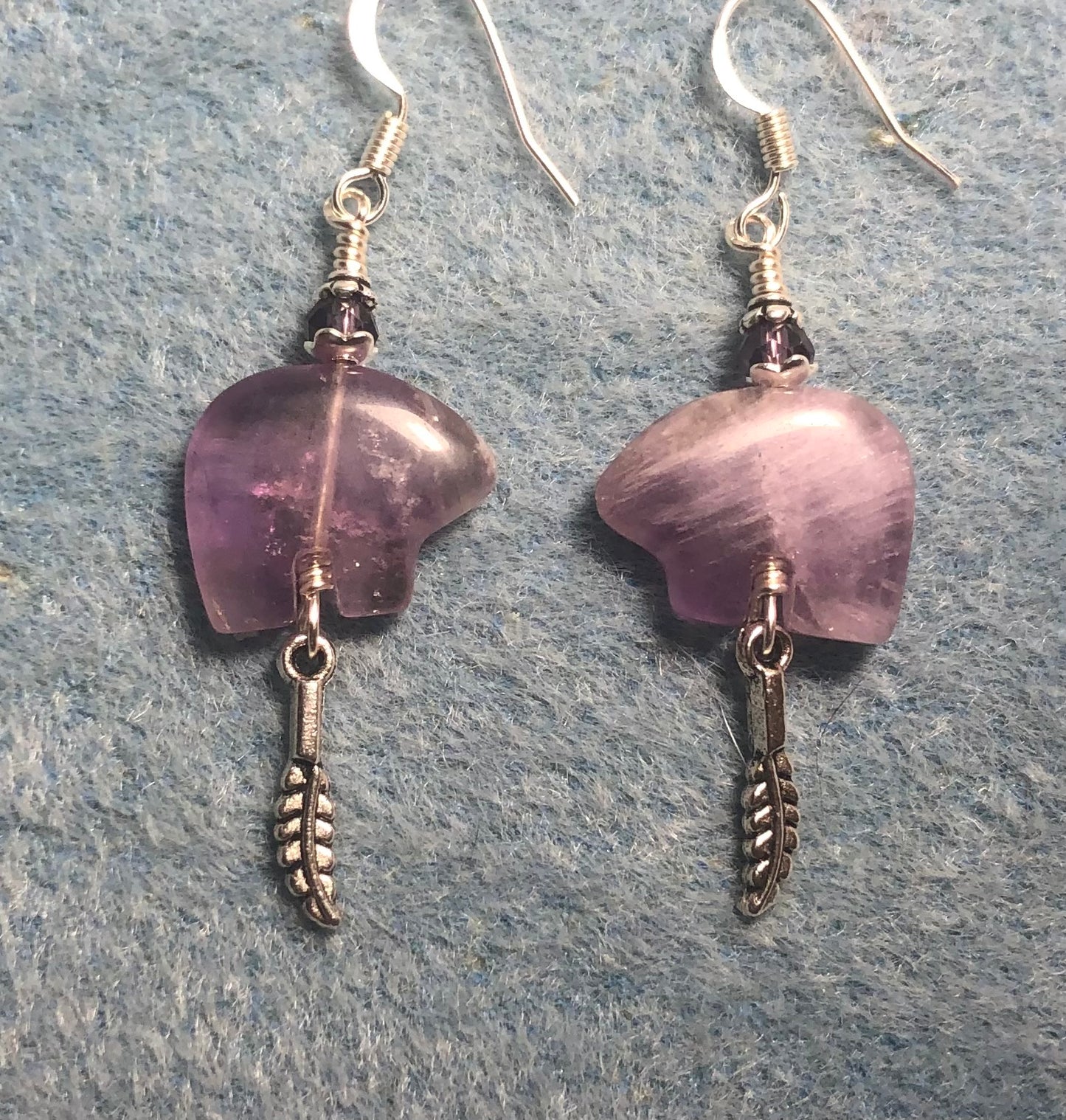 Light purple amethyst gemstone Zuni bear fetish bear earrings adorned with purple crystal beads and tiny silver feather charms.
