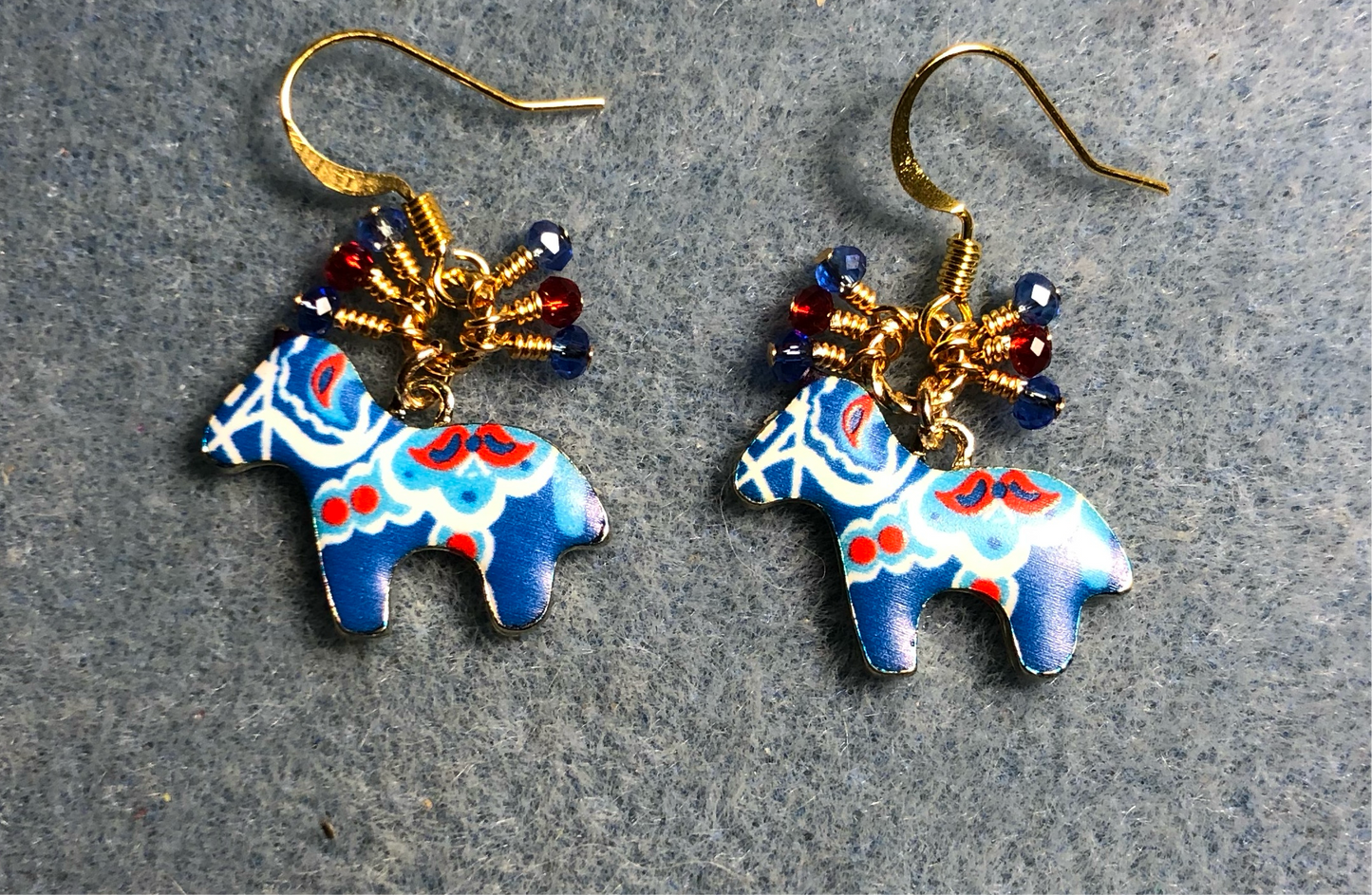 Blue and red enamel horse charm earrings adorned with tiny dangling blue and red Chinese crystal beads.
