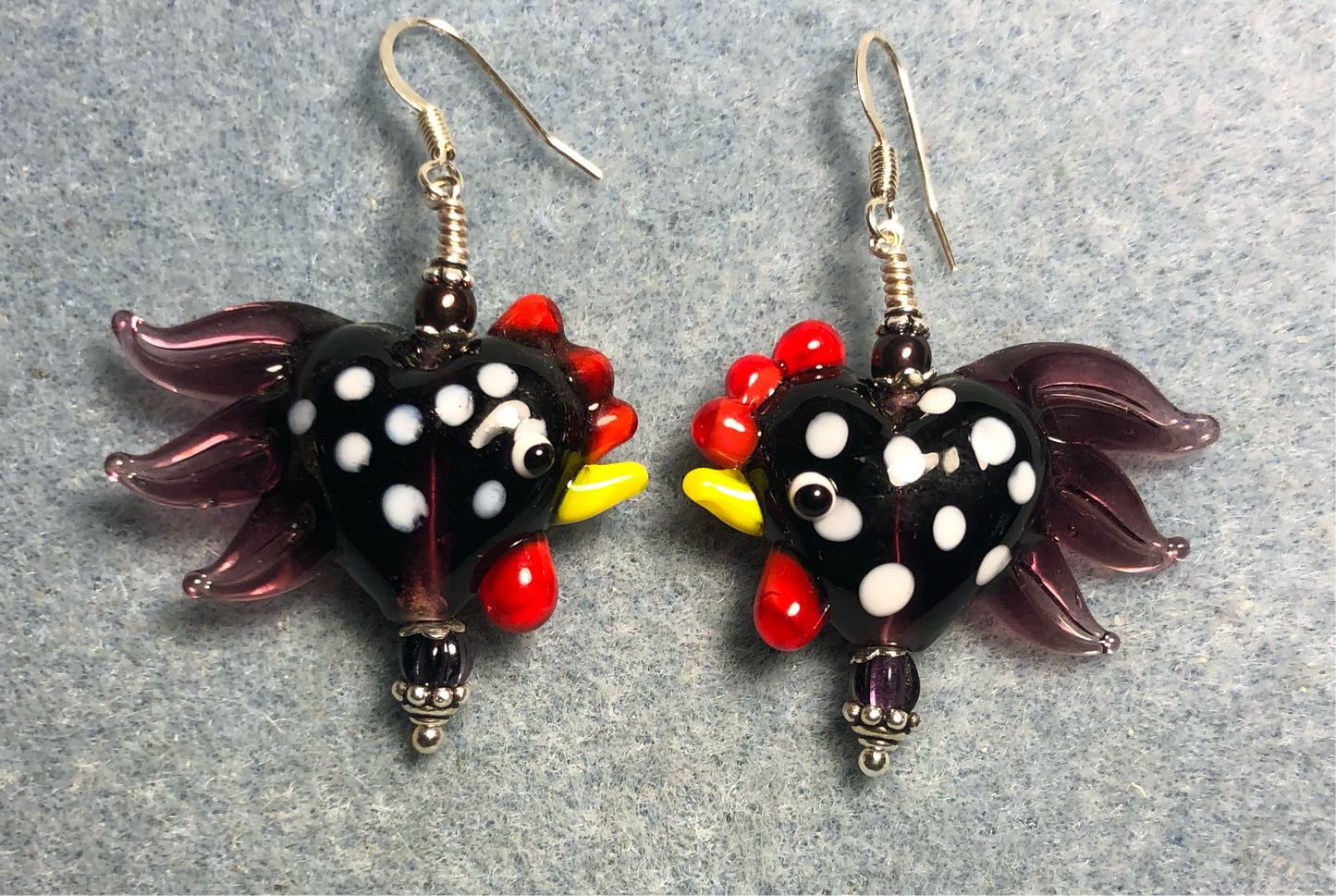 Black with white spots and purple tails heart shaped lamp work rooster bead earrings adorned with purple Czech glass beads.