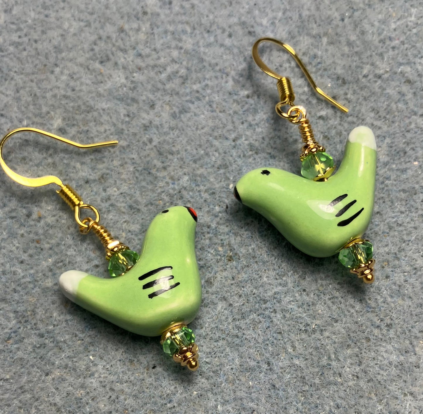Small green and white ceramic bird bead earrings adorned with green Chinese crystal beads.