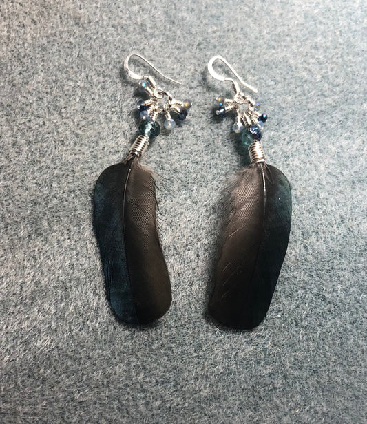 Small blue magpie feather earrings adorned with small blue Czech glass beads and tiny dangling blue Chinese crystal beads.