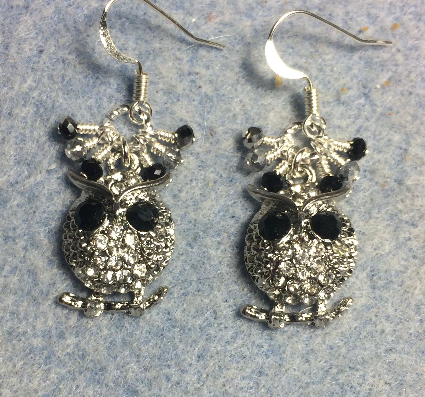 Silver and rhinestone owl charm earrings adorned with tiny dangling black and clear Chinese crystal beads.