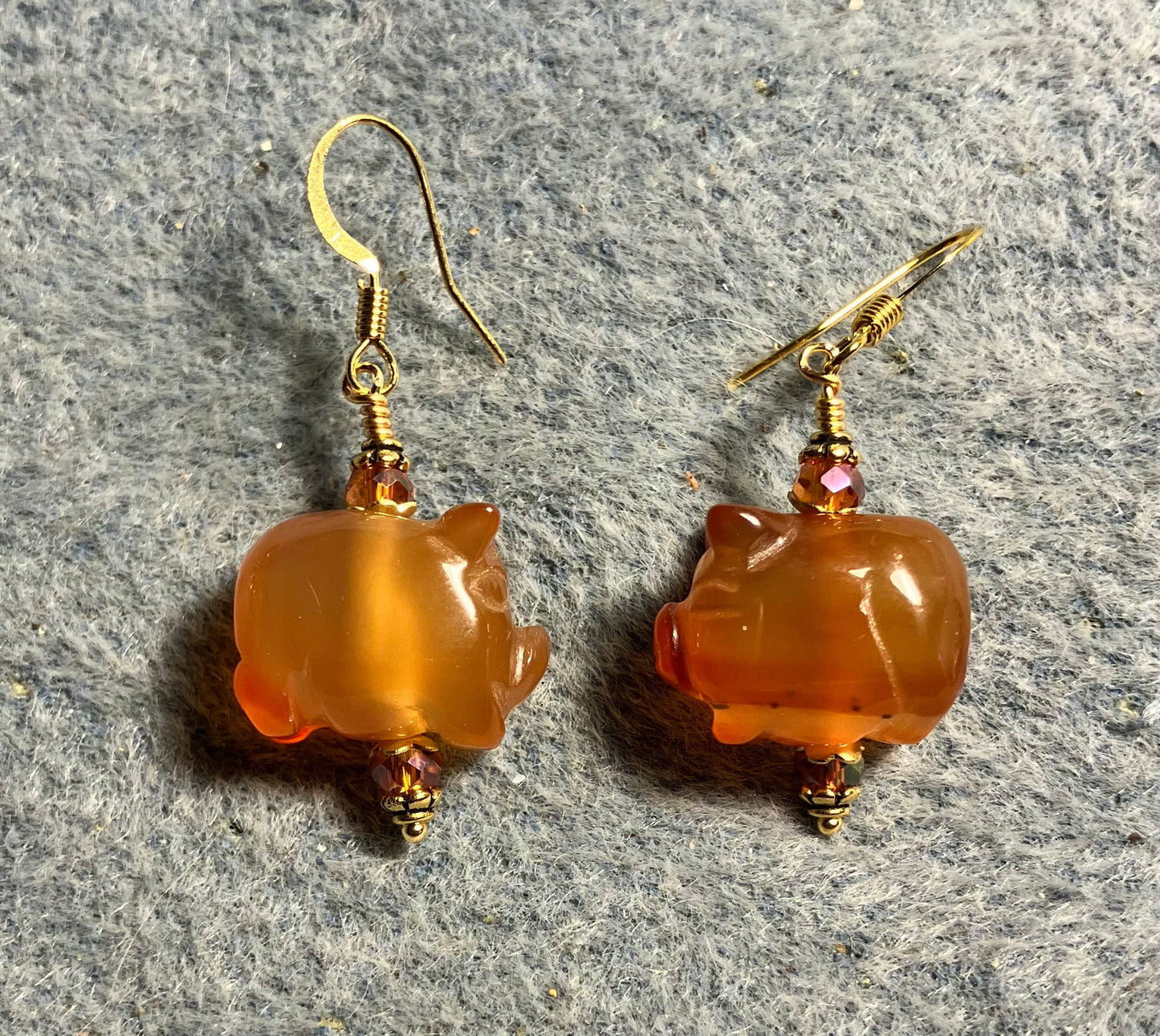Orange carnelian gemstone pig bead earrings adorned with orange Chinese crystal beads.