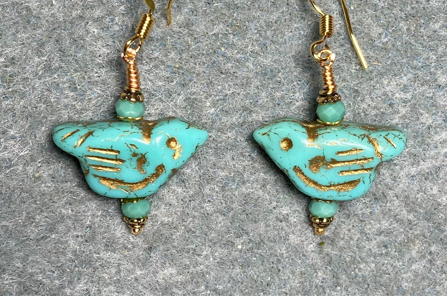 Opaque turquoise (with gold wash) Czech glass bird bead earrings adorned with turquoise Chinese crystal beads.