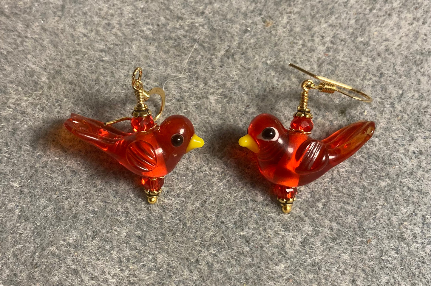 Translucent red lamp work songbird bead earrings adorned with red Chinese crystal beads.