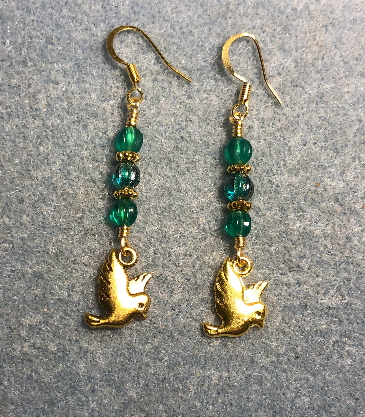 Gold dove charm earrings adorned with small teal Czech glass melon beads