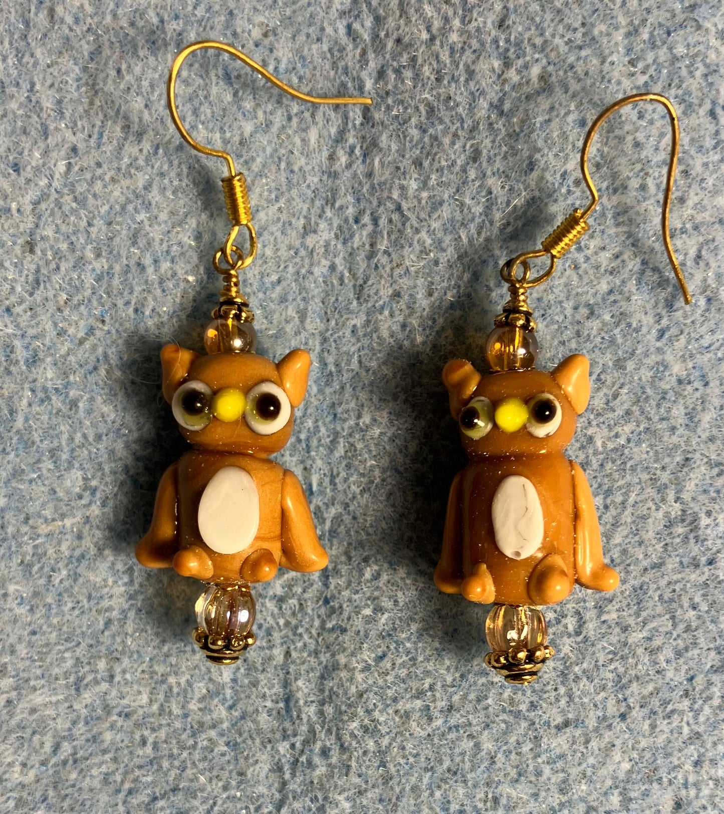Tan and white lamp work owl bead earrings adorned with tan Czech glass beads.