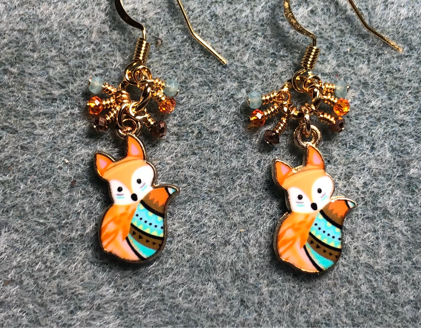 Small orange, turquoise, and brown enamel fox charm earrings adorned with tiny dangling orange, turquoise, and brown Chinese crystal beads.