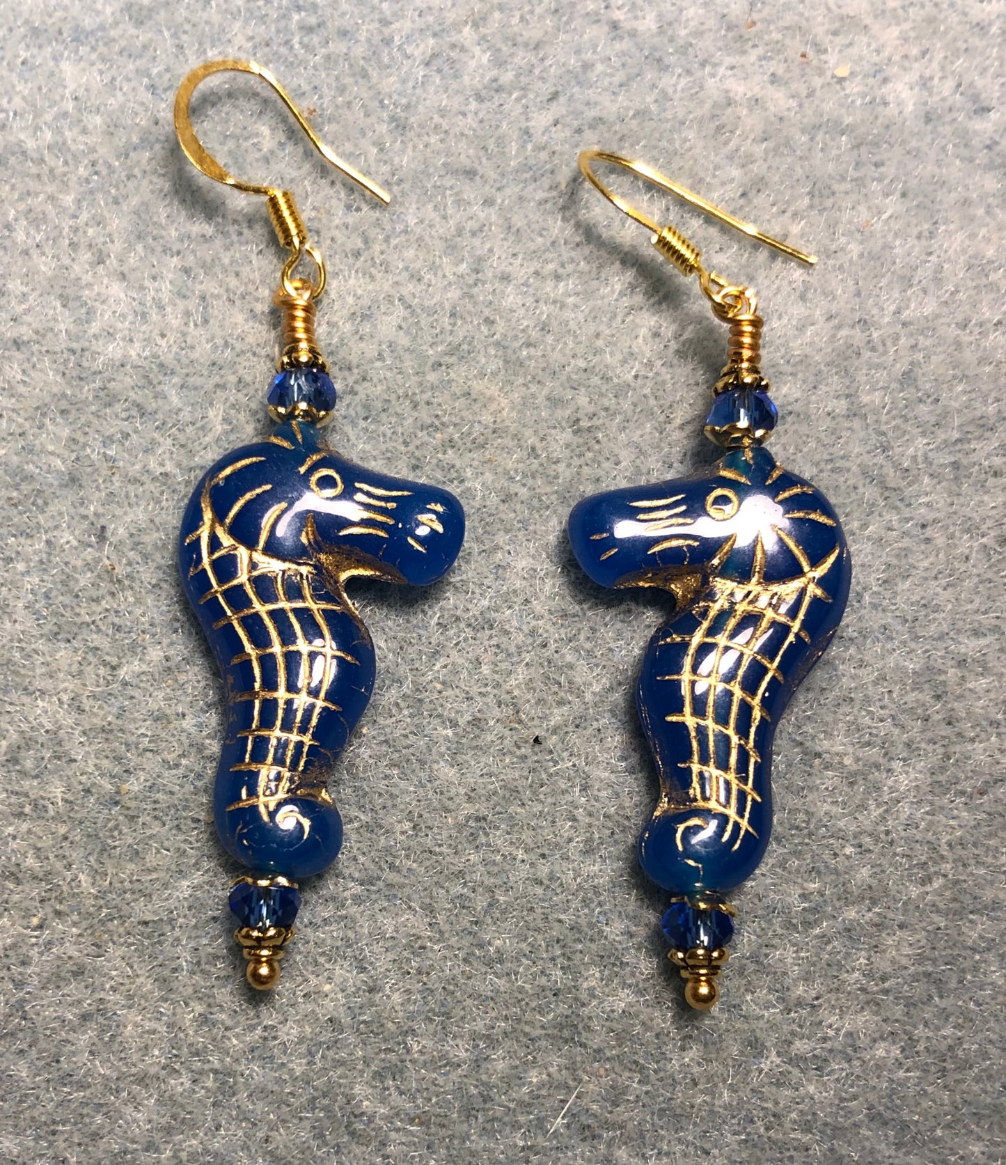 Blue (with gold inlay) Czech glass seahorse bead earrings adorned with blue Chinese crystal beads.