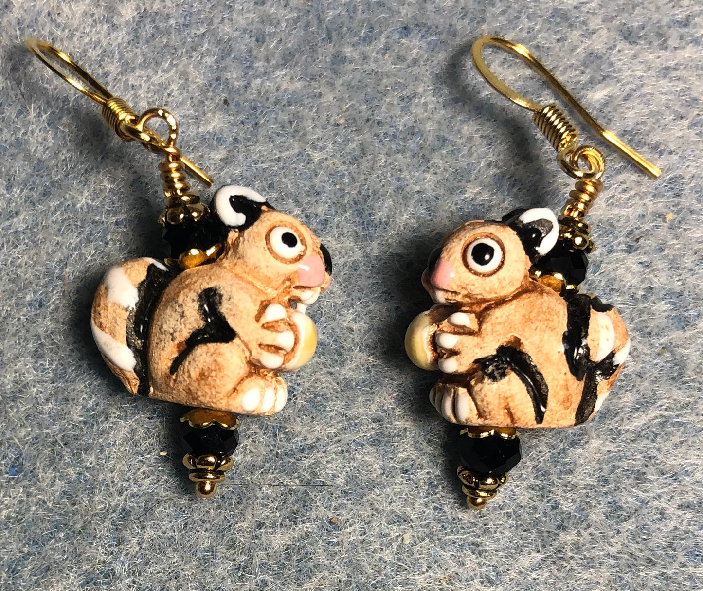 Small tan and black ceramic squirrel bead earrings adorned with black Chinese crystal beads.