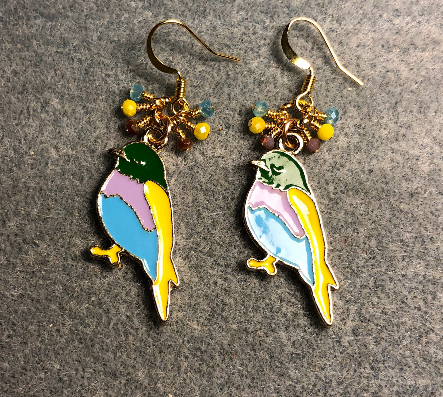 Aqua, violet, and yellow enamel songbird charm earrings adorned with tiny dangling aqua, violet, and yellow Chinese crystal beads.