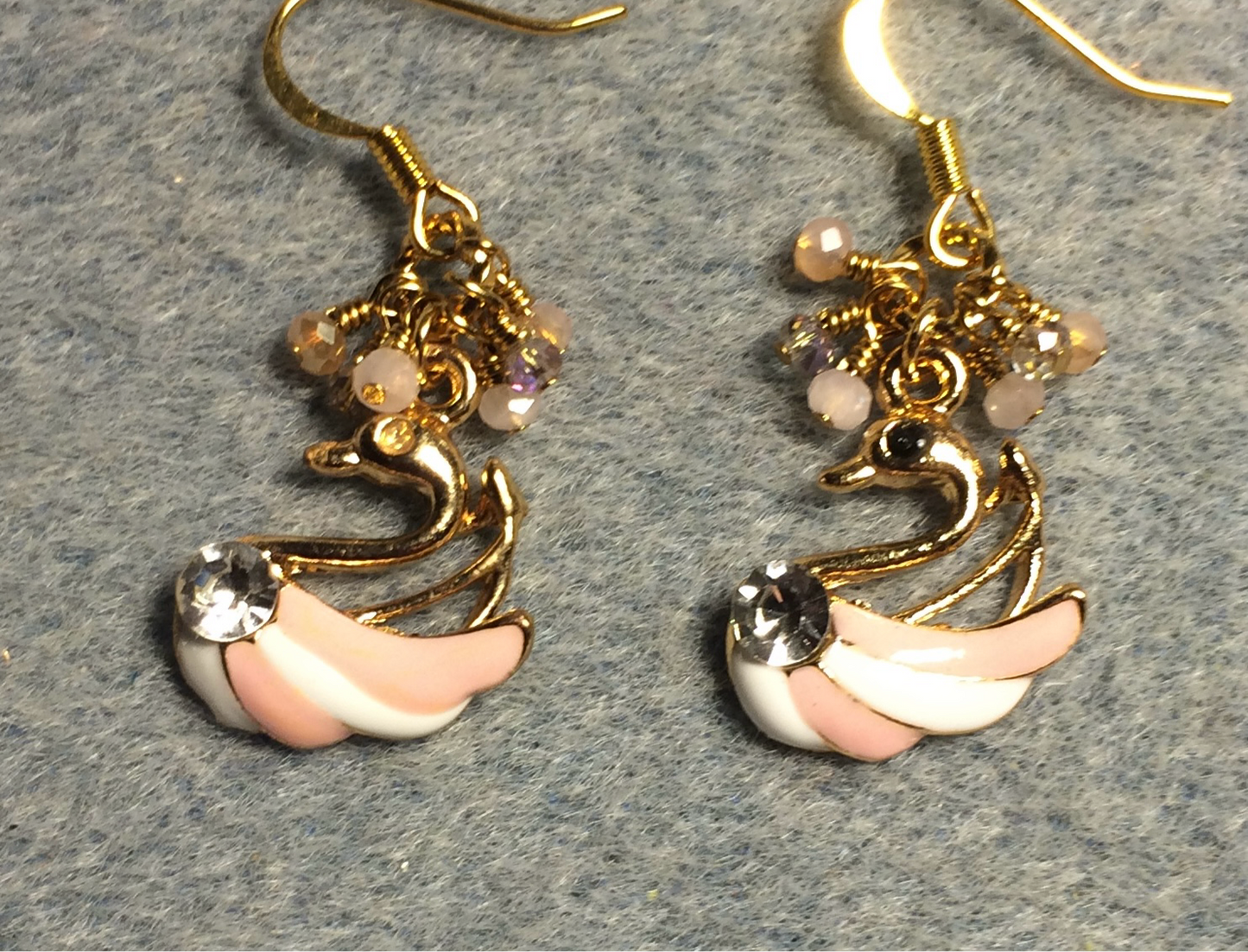 Peach and white enamel and rhinestone striped swan charm earrings adorned with tiny dangling peach and clear Chinese crystal beads.
