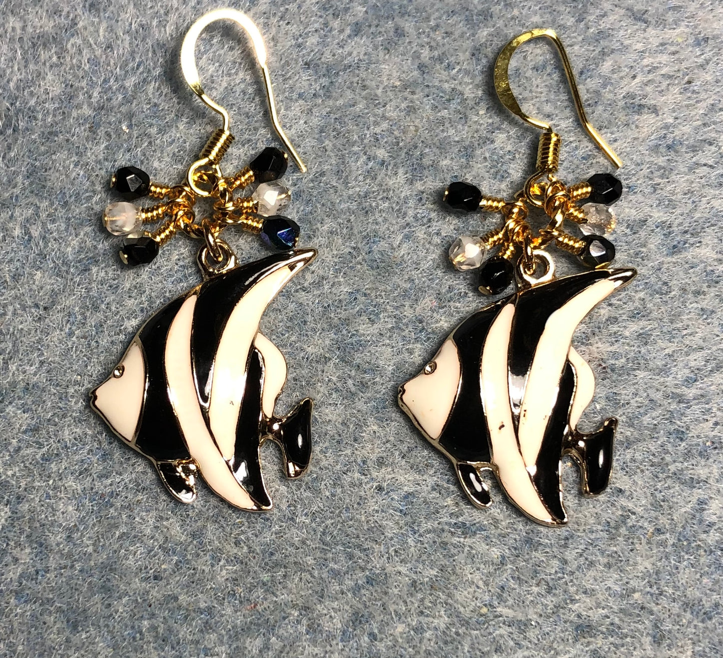 Black and white enamel striped angelfish charm earrings adorned with small dangling black and white Czech glass beads.