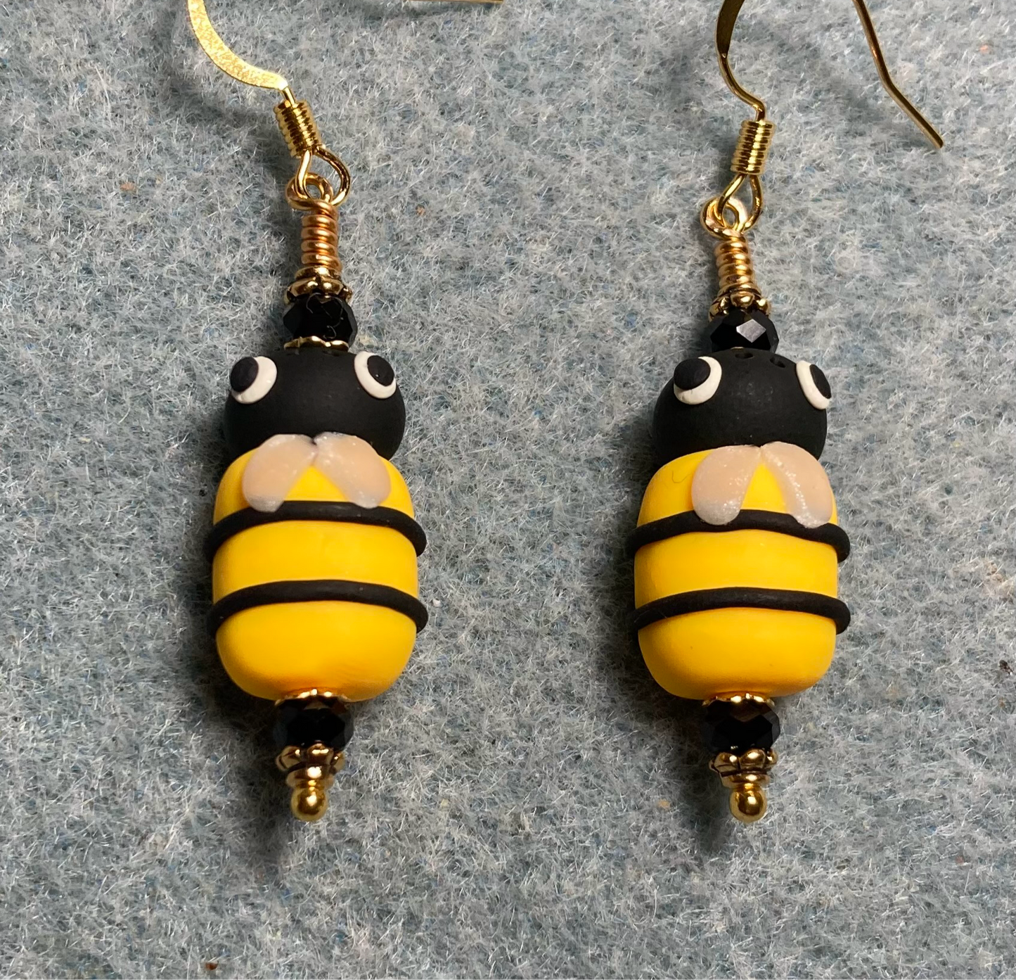 Yellow and black polymer clay striped honeybee bead earrings adorned with black Chinese crystal beads.