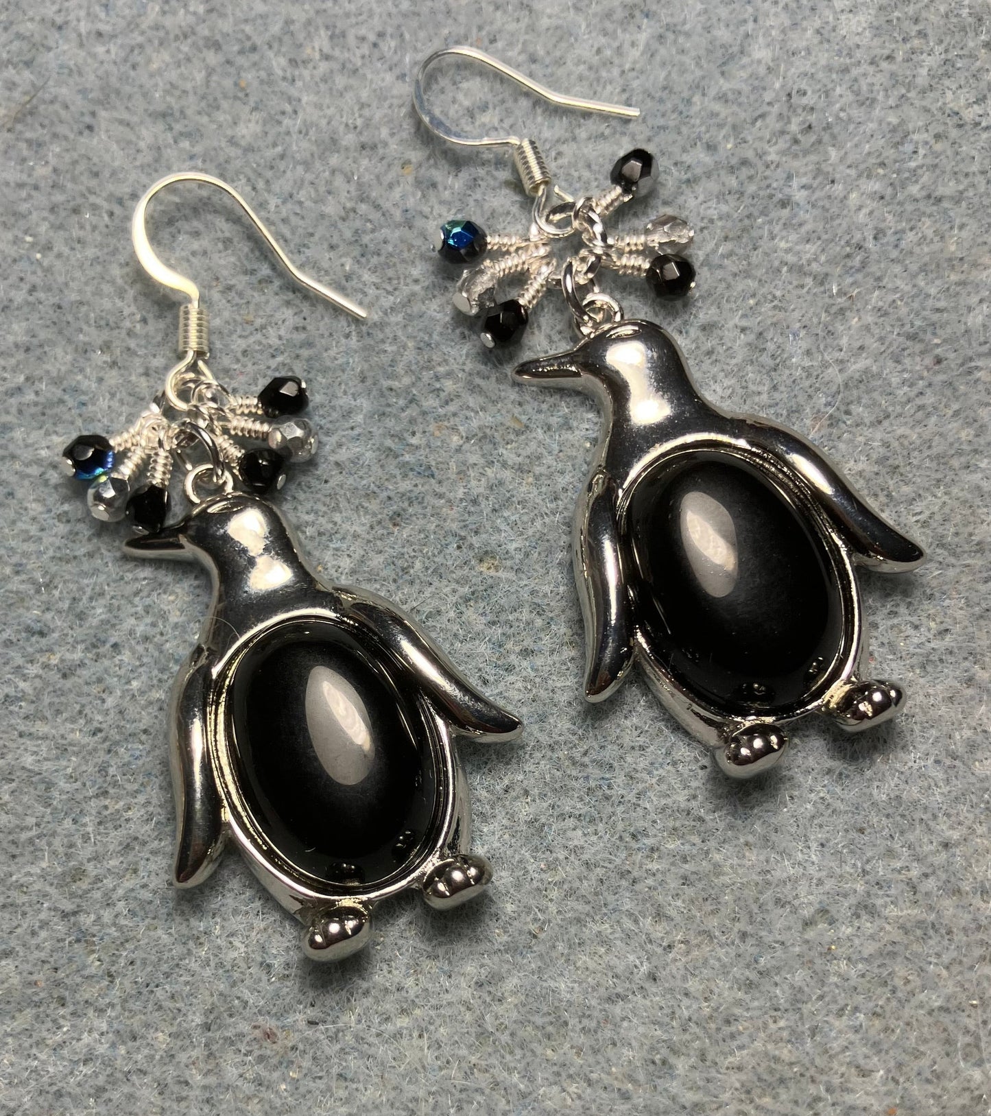 Large silver and black onyx gemstone penguin charm earrings adorned with small dangling black and silver Czech glass beads.