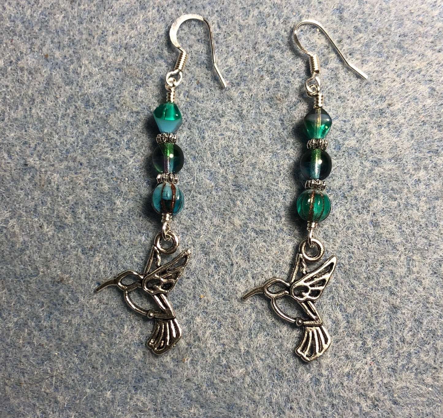 Silver hummingbird charm earrings adorned with multicolored (turquoise, green, purple) Czech glass beads