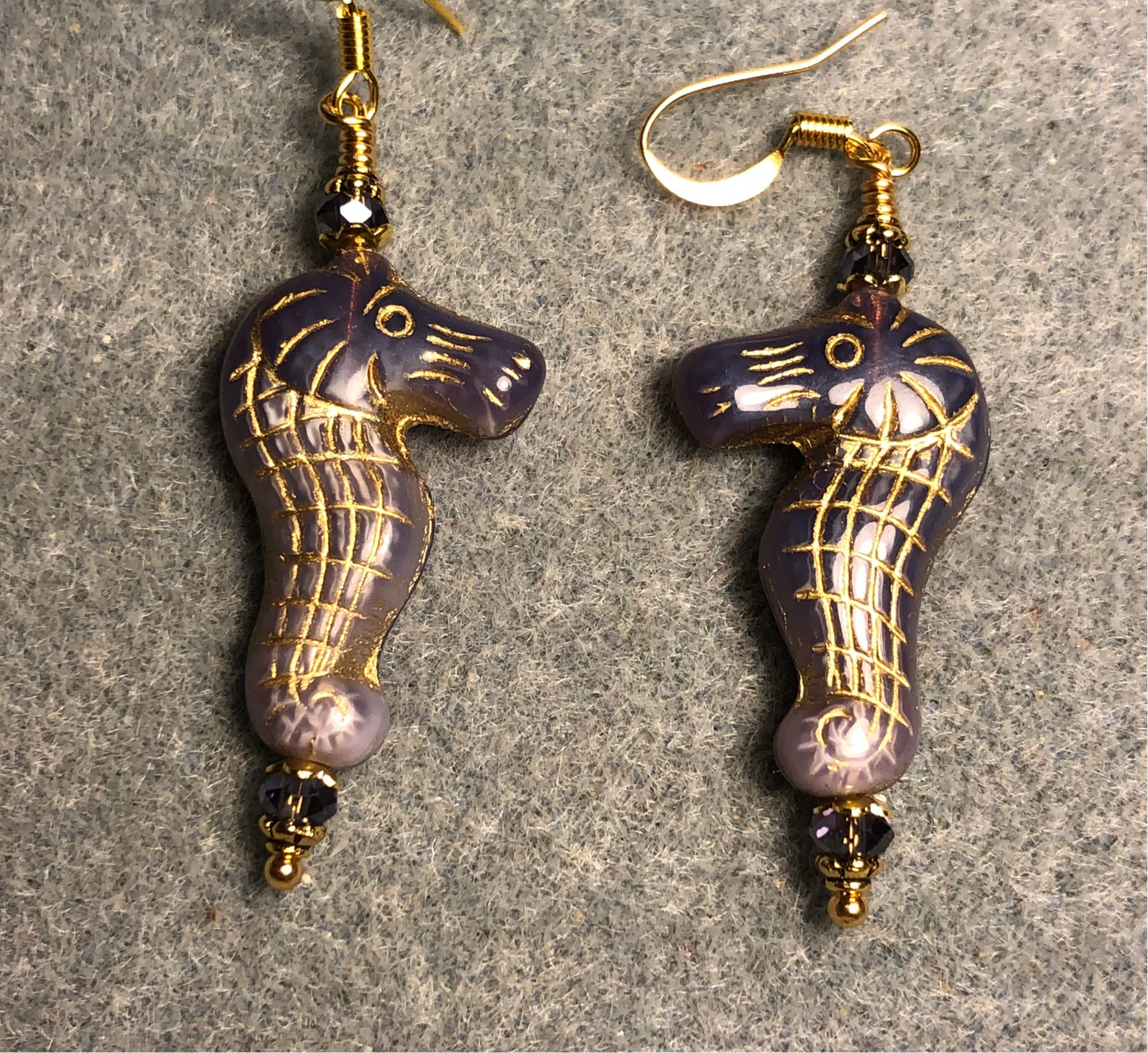 Purple violet (with gold inlay) Czech glass seahorse bead earrings adorned with purple Chinese crystal beads.